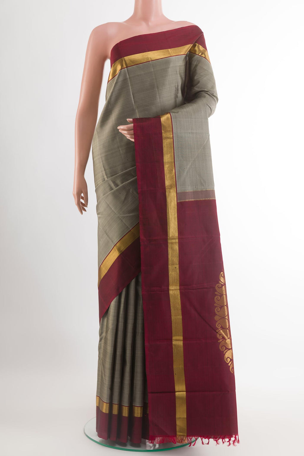Grey Kanchipuram Silk Saree with Zari Butta on the body and Zari Border.  displayed on a mannequin