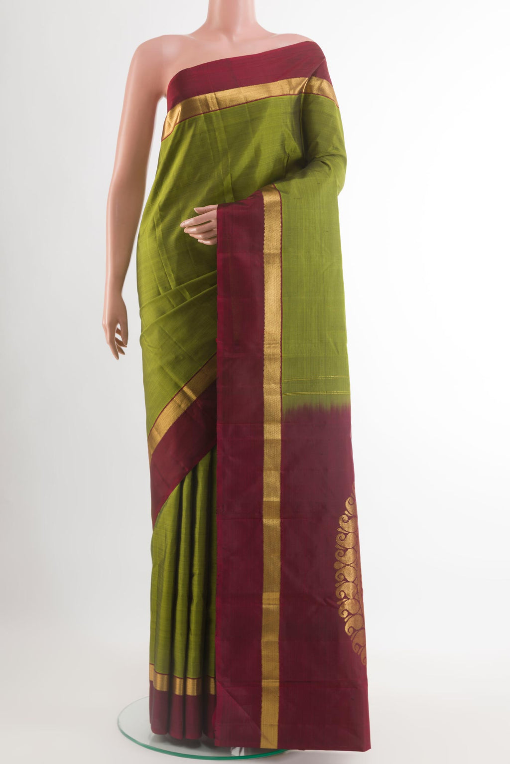 Green Kanchipuram Silk Saree with Plain Body and Zari Border.  displayed on a mannequin