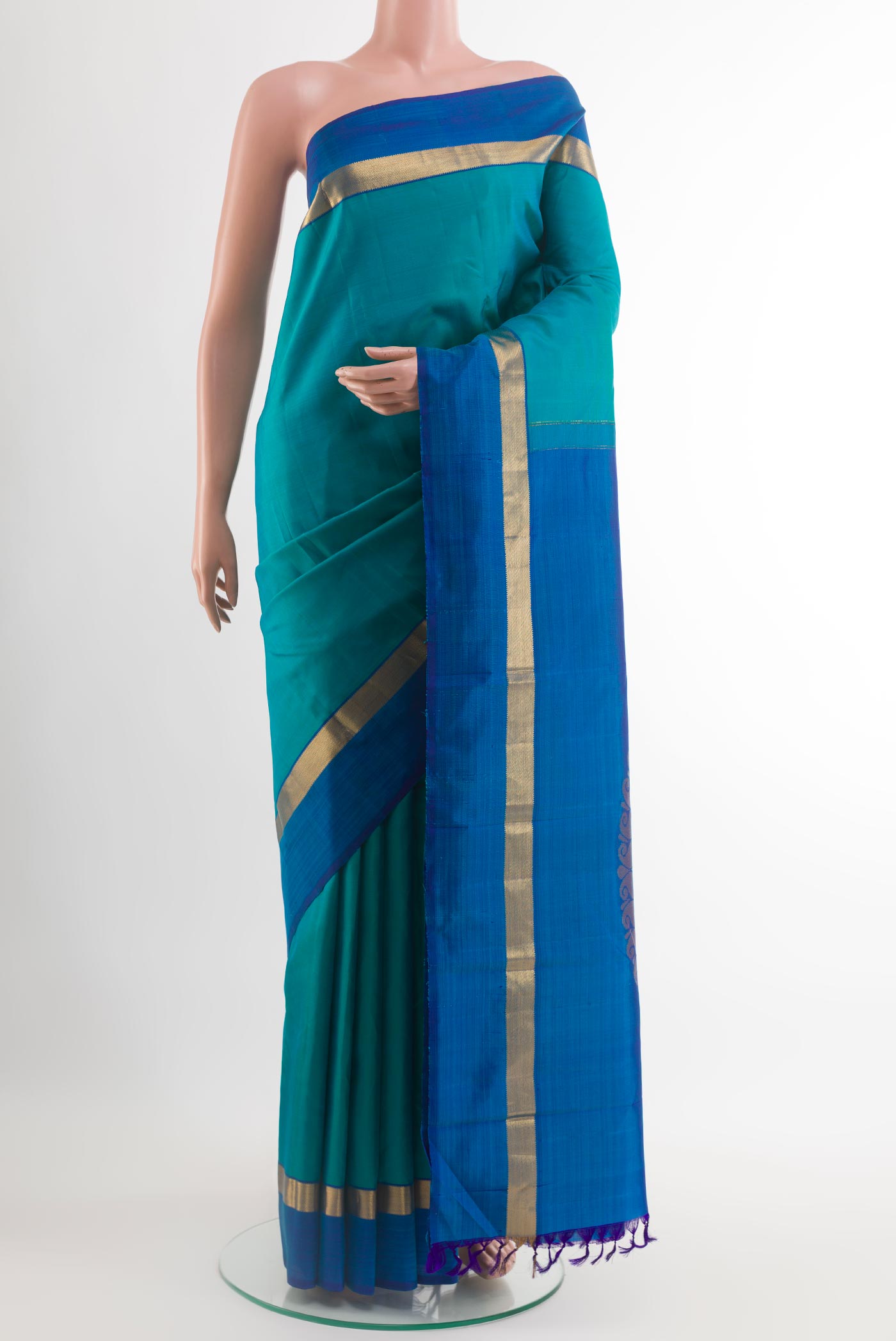 Light Blue Kanchipuram Silk Saree with Plain Body and Zari Border.  displayed on a mannequin