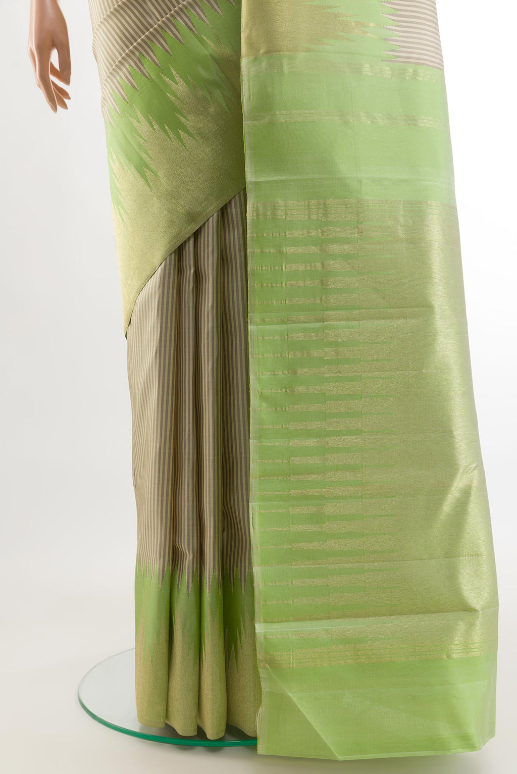 Pleats and pallu of Off White Kanchipuram Silk Saree with Stripes on the body and Zari Border. 