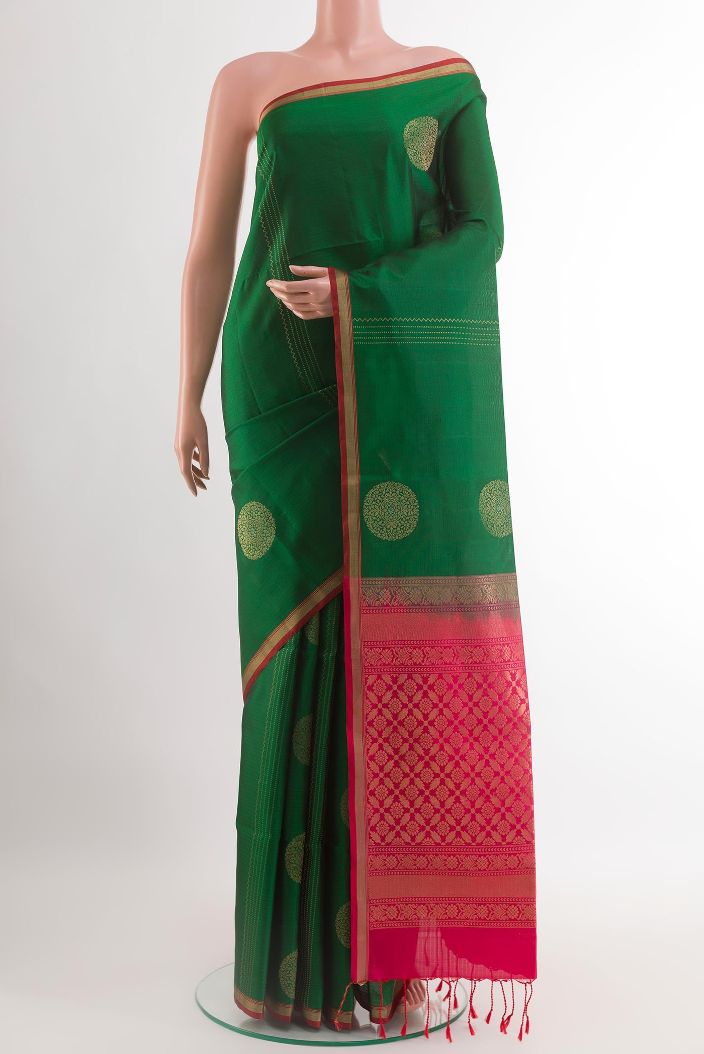 Green Soft Silk Saree with Checked design on the body and Zari Border.  displayed on a mannequin