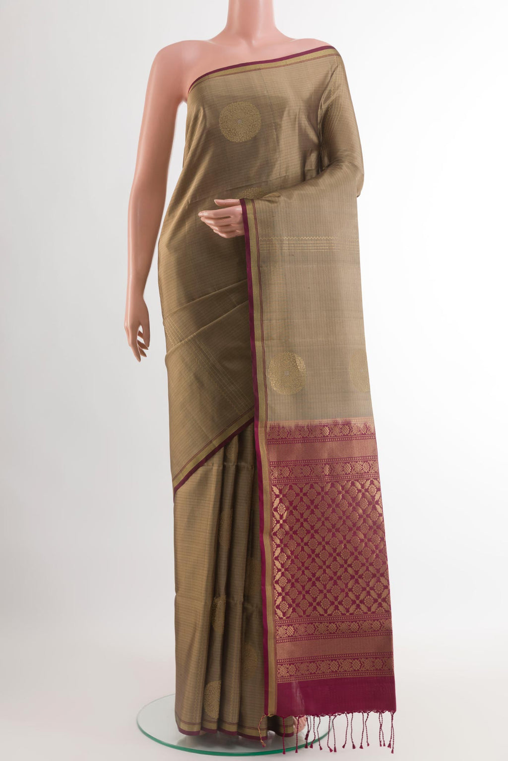 Brown Soft Silk Saree with Zari Butta on the body and Zari Border.  displayed on a mannequin