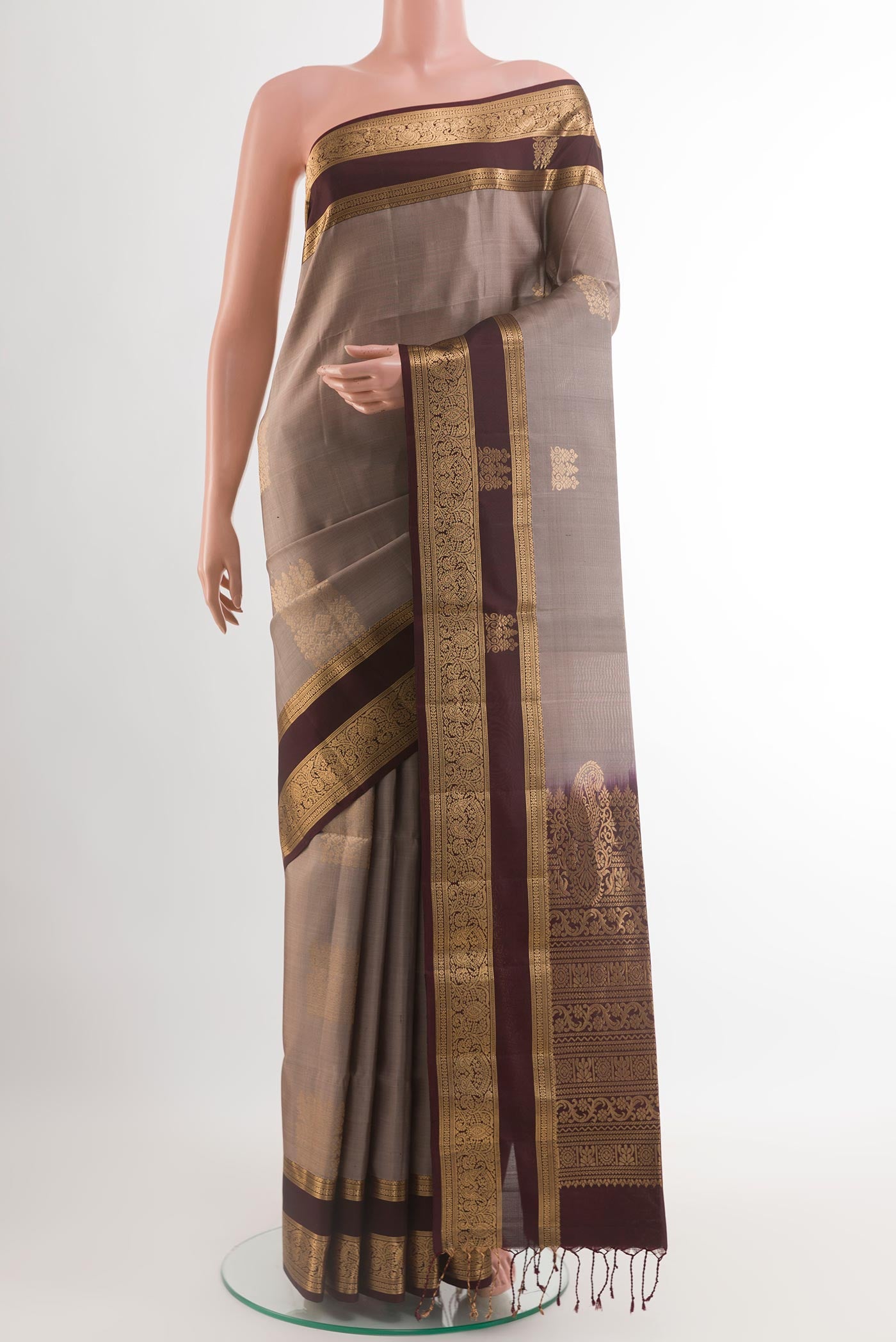 Grey Soft Silk Saree with Zari Butta on the body and Zari Border.  displayed on a mannequin