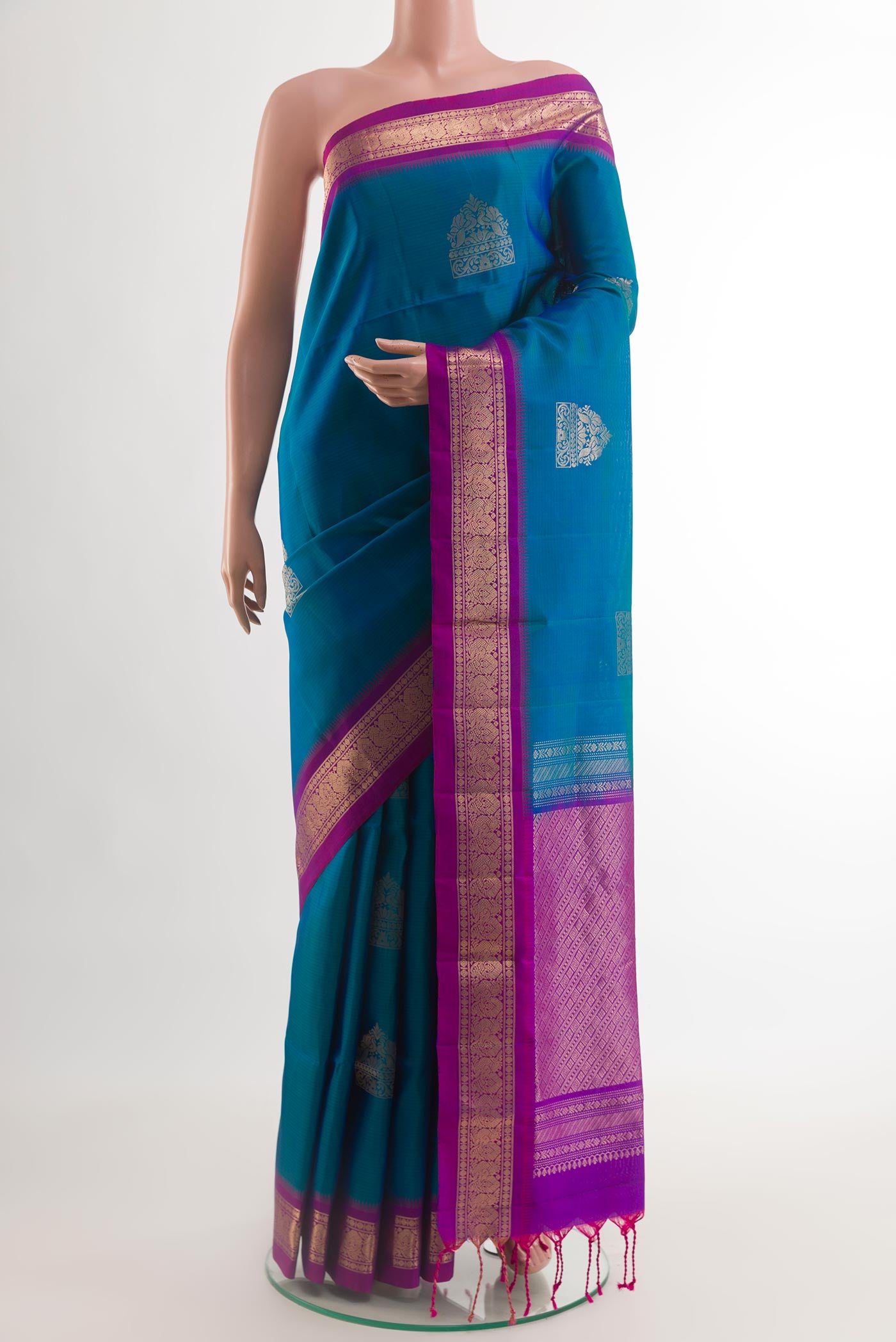 Blue Soft Silk Saree with Zari Butta on the body and Zari Border.  displayed on a mannequin