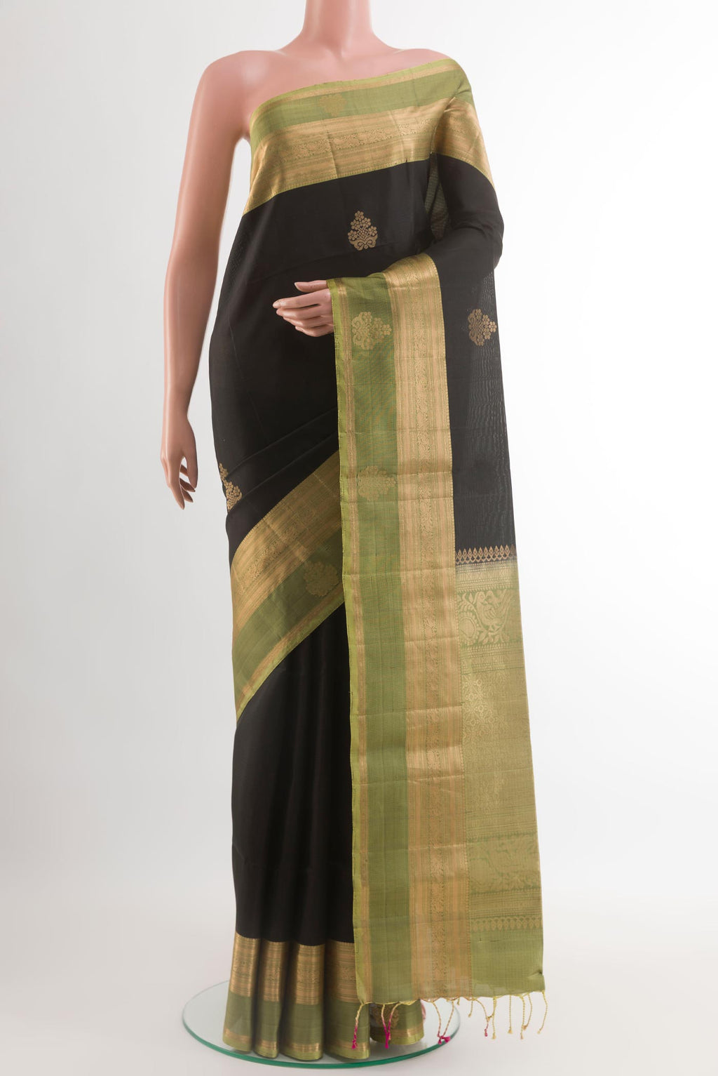Black Soft Silk Saree with Zari Butta on the body and Zari Border.  displayed on a mannequin