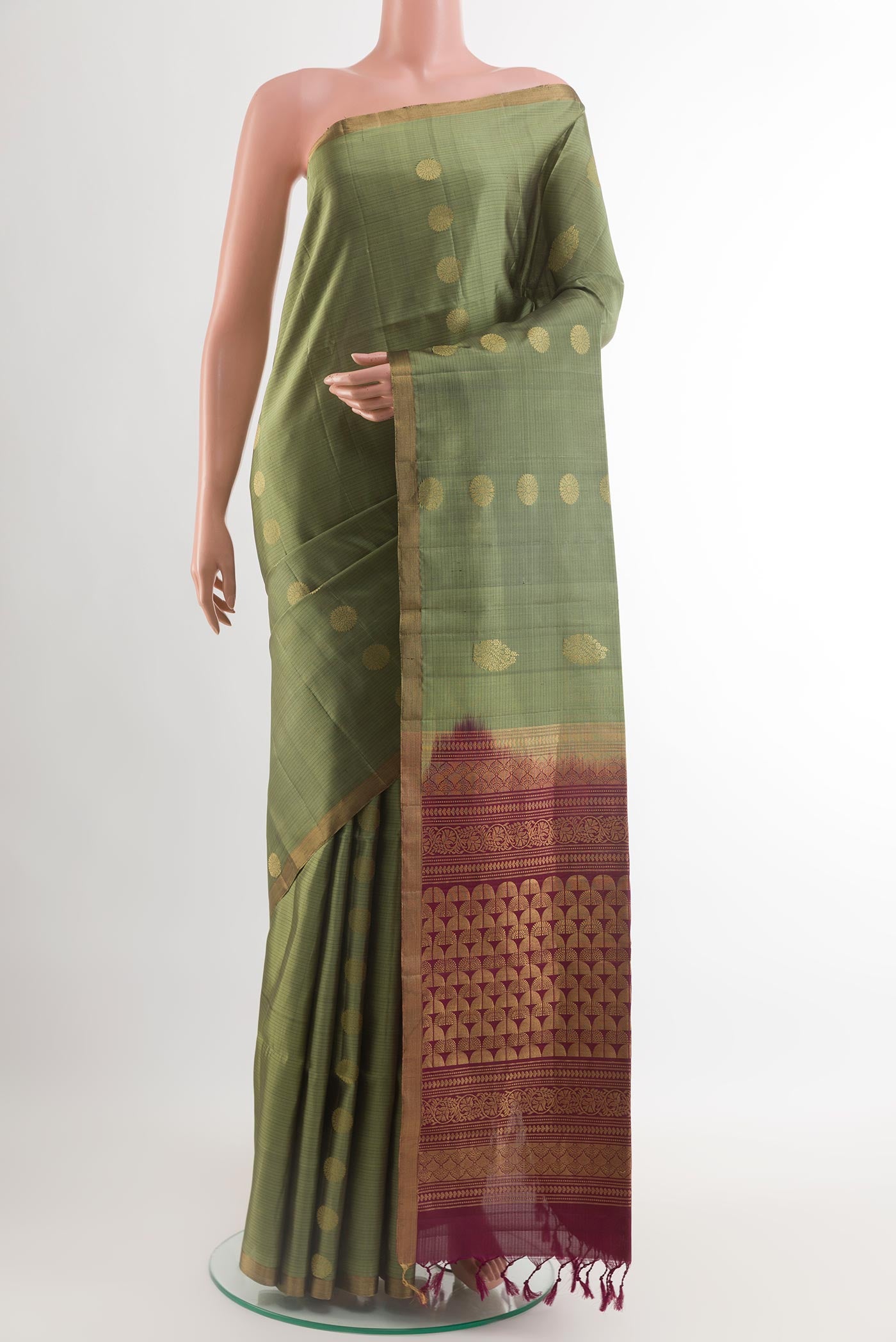Mehandi Green Soft Silk Saree with Zari Butta on the body and Zari Border.  displayed on a mannequin