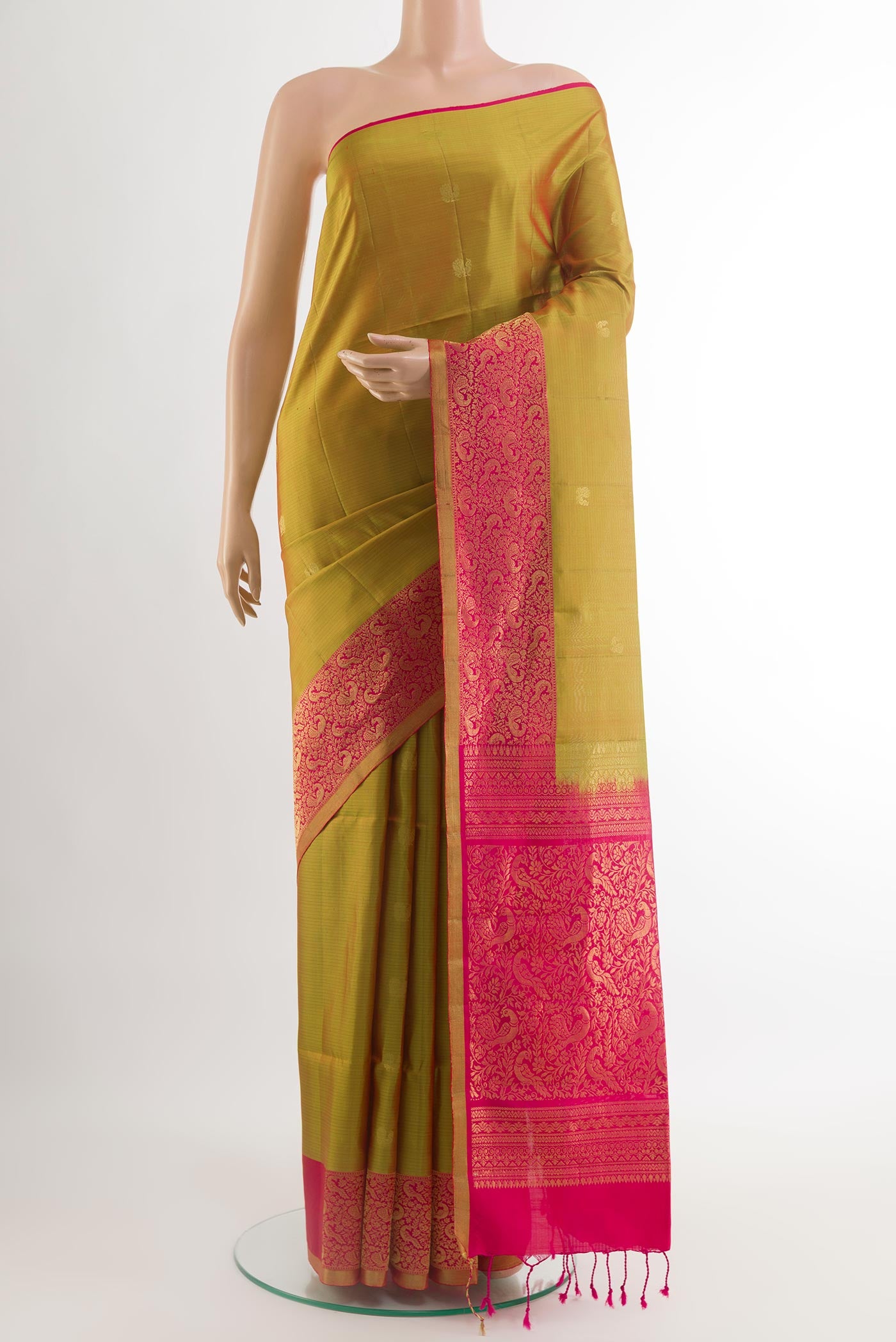 Yellow Soft Silk Saree with Zari Butta on the body and Zari Border.  displayed on a mannequin