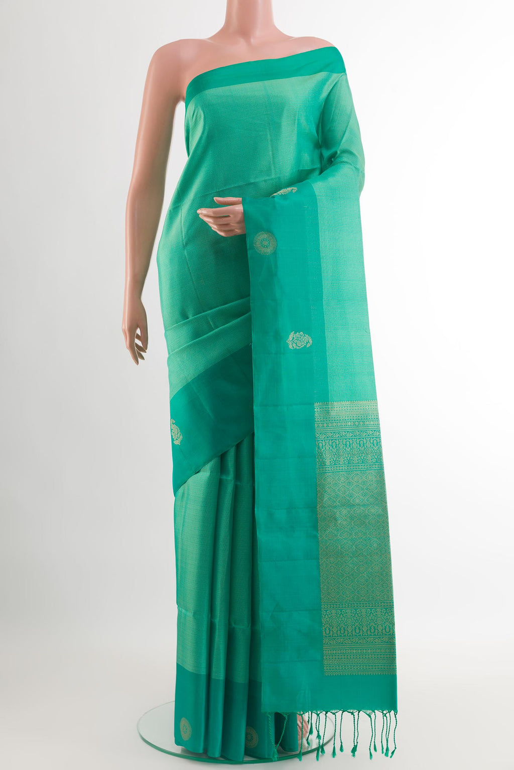 Sea Green Soft Silk Saree with Checked design on the body and Zari Border.  displayed on a mannequin