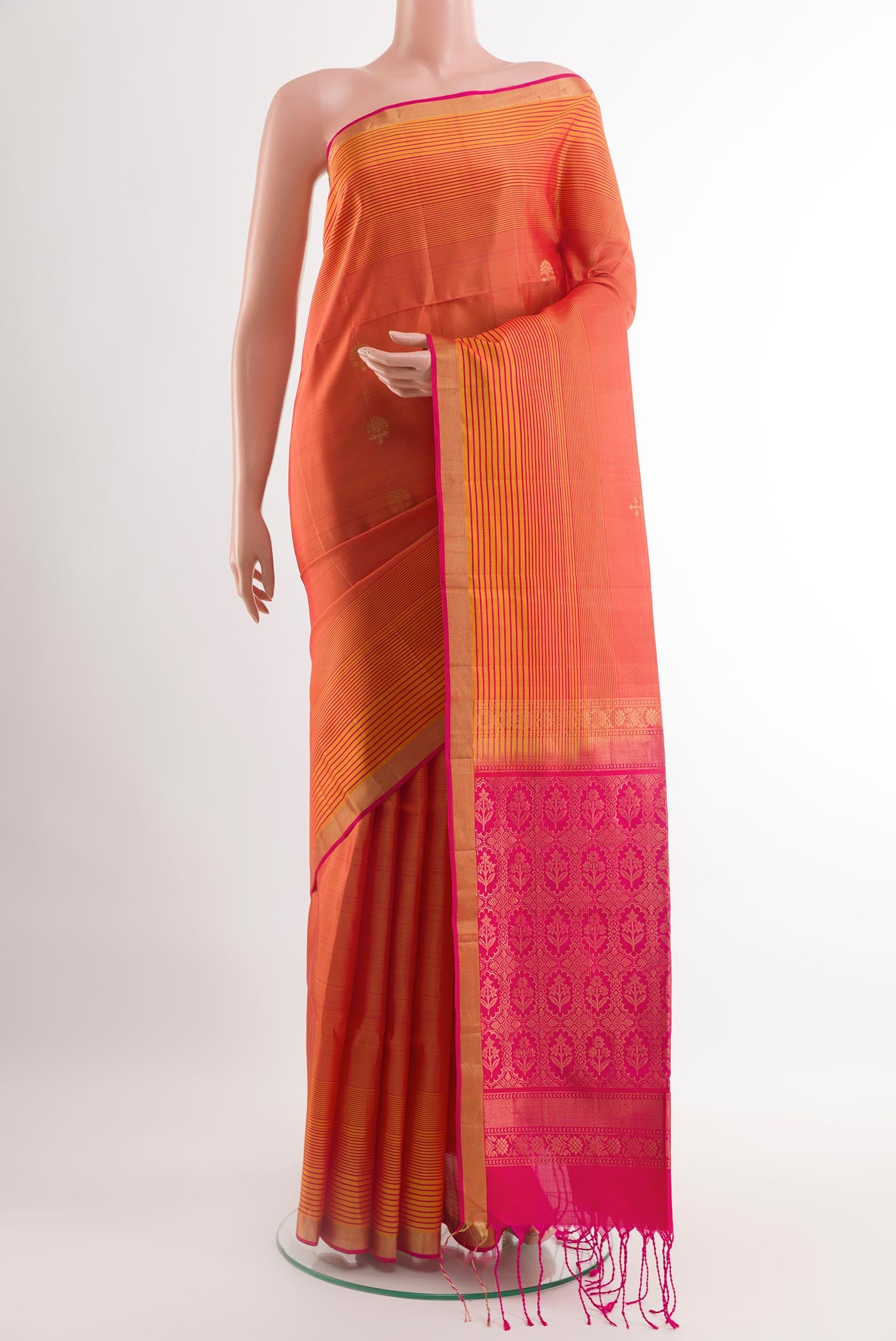 Brick Orange Soft Silk Saree with Zari Butta on the body and Zari Border.  displayed on a mannequin