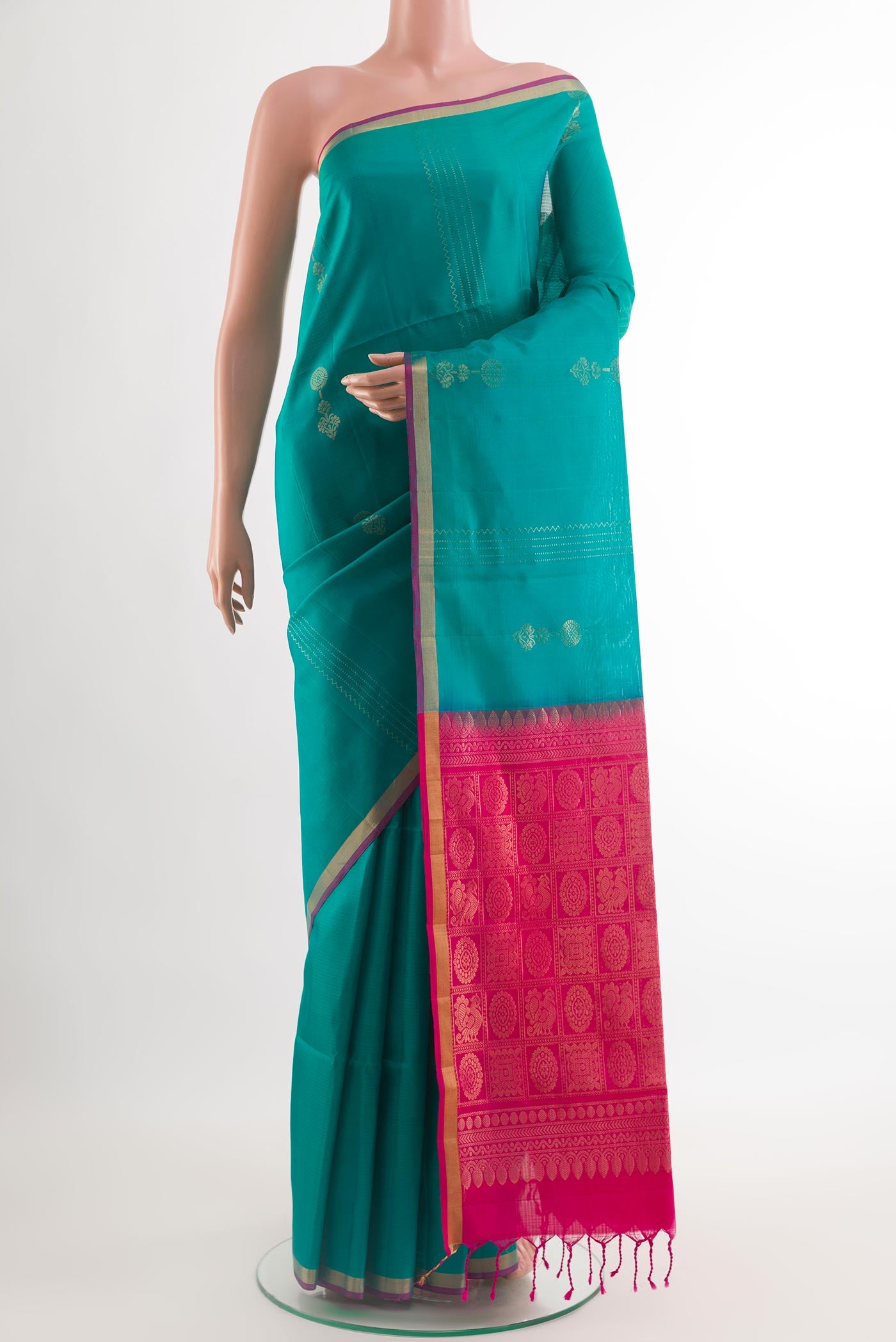 Sea Green Soft Silk Saree with Zari Butta on the body and Zari Border.  displayed on a mannequin