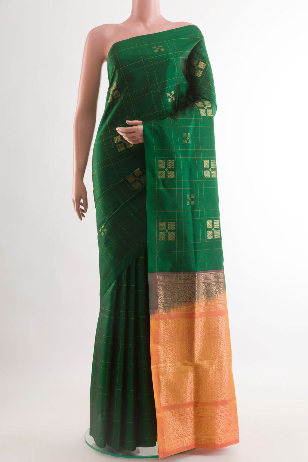 Green Soft Silk Saree with Zari Butta on the body and Zari Border.  displayed on a mannequin