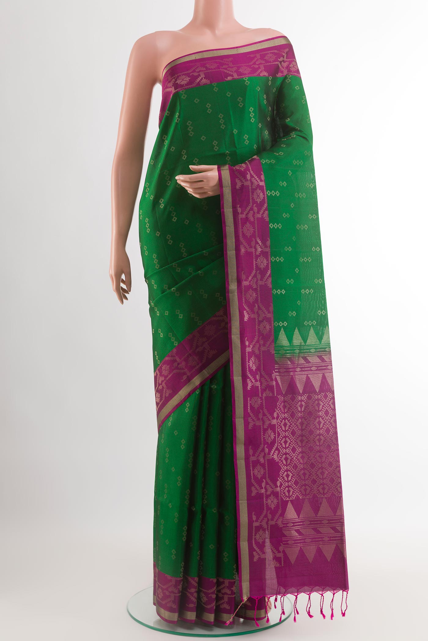 Green Soft Silk Saree with Zari Butta on the body and Zari Border.  displayed on a mannequin