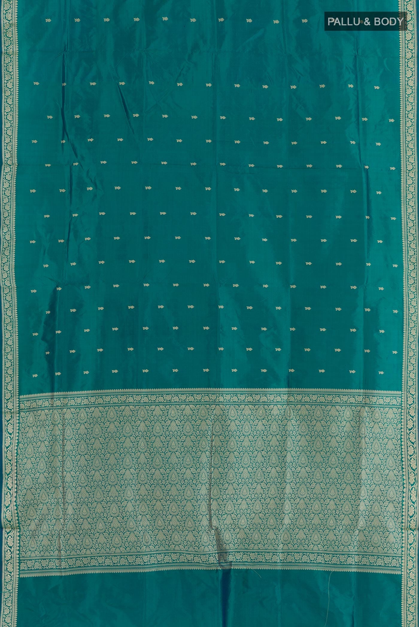 Flat view of Teal Banarasi Katan Silk Saree with Zari Butta on the body and Zari Border. 