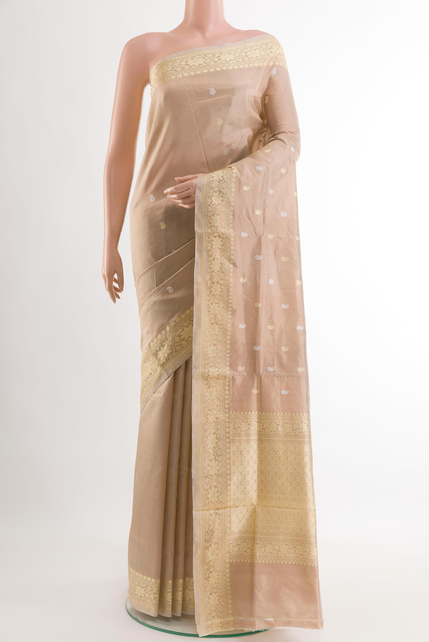 Beige Banarasi Katan Silk Saree with Zari Butta on the body and Zari Border.  displayed on a mannequin