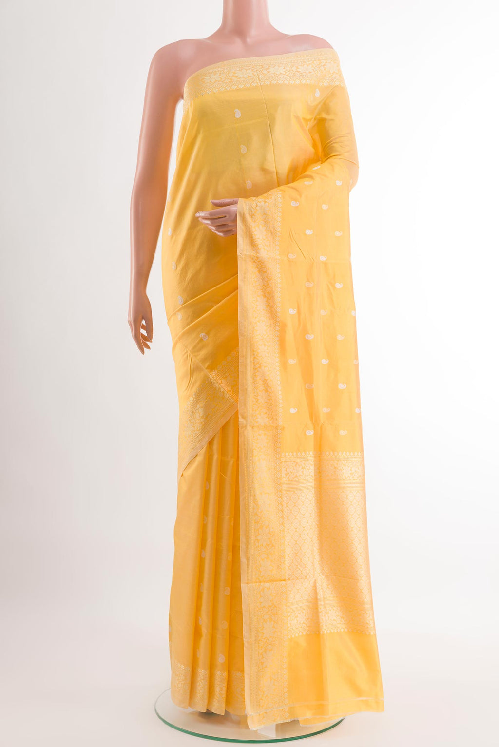 Yellow Banarasi Katan Silk Saree with Zari Butta on the body and Zari Border.  displayed on a mannequin