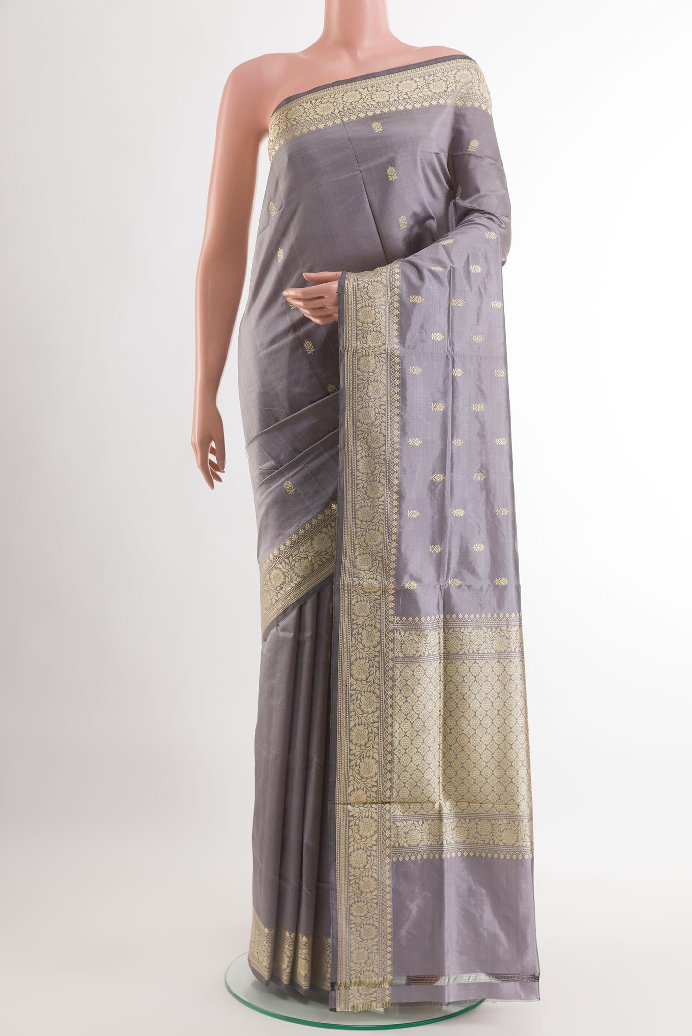 Grey Banarasi Katan Silk Saree with Zari Butta on the body and Zari Border.  displayed on a mannequin