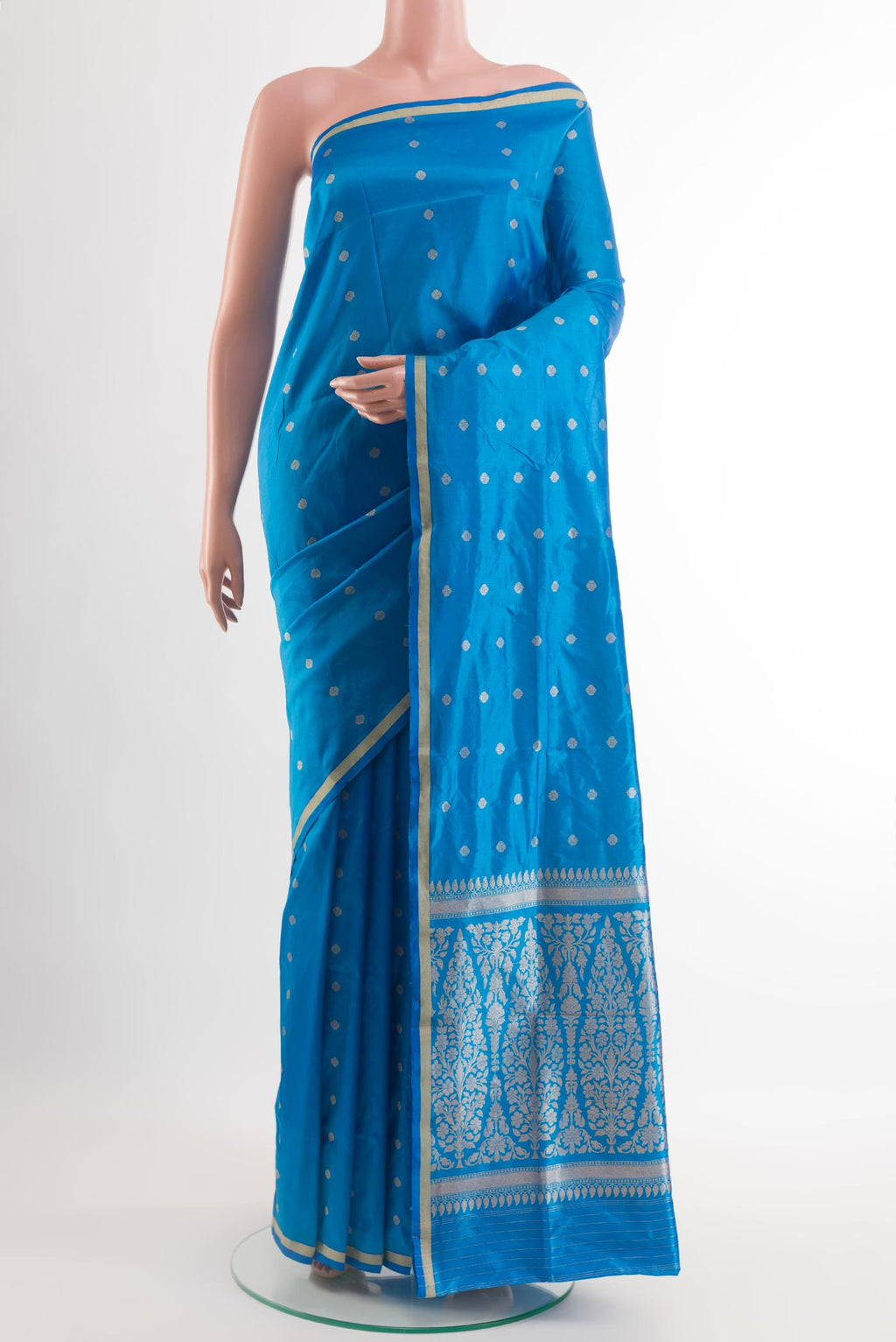 Blue Banarasi Katan Silk Saree with Zari Butta on the body and Zari Border.  displayed on a mannequin