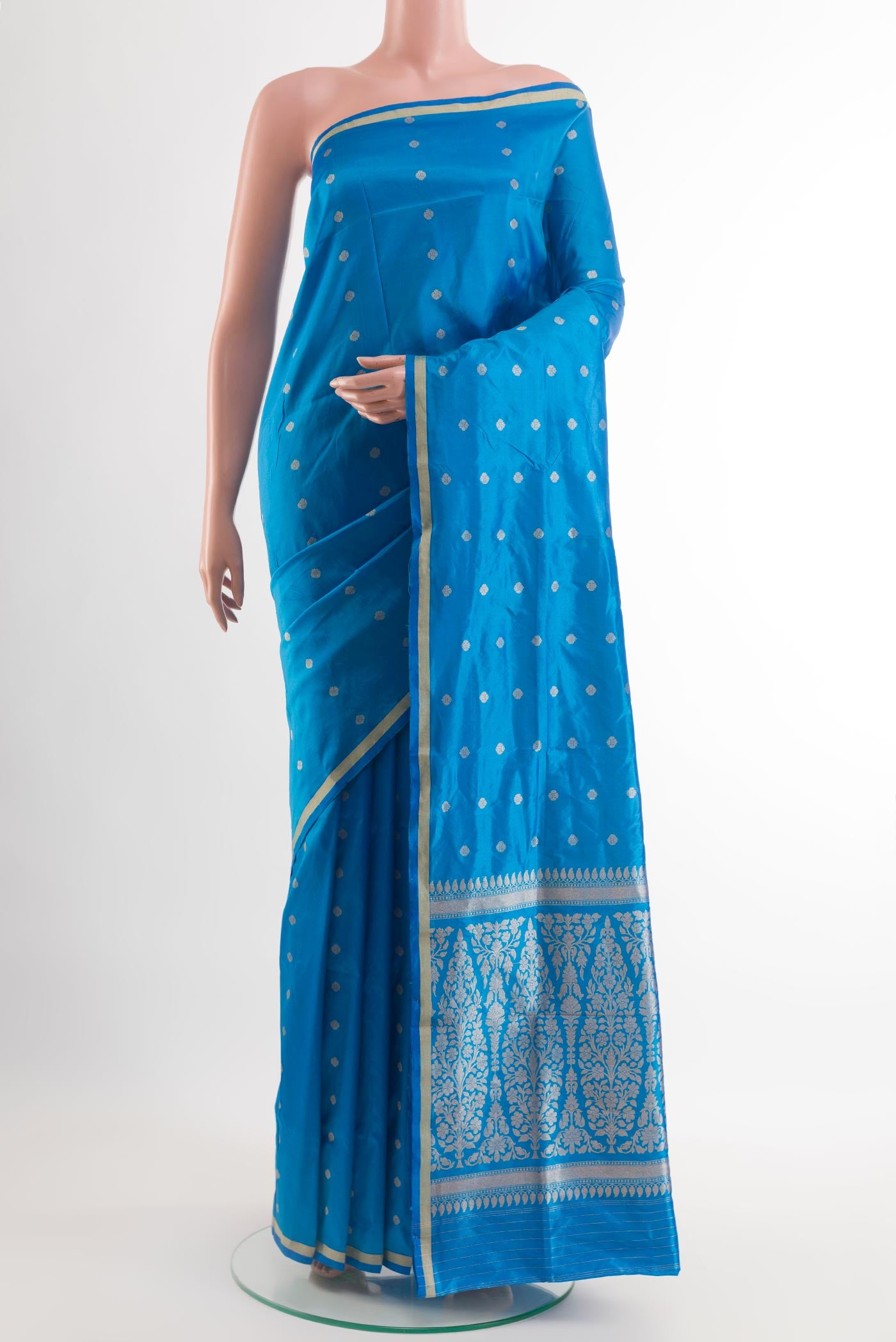 Blue Banarasi Katan Silk Saree with Zari Butta on the body and Zari Border.  displayed on a mannequin