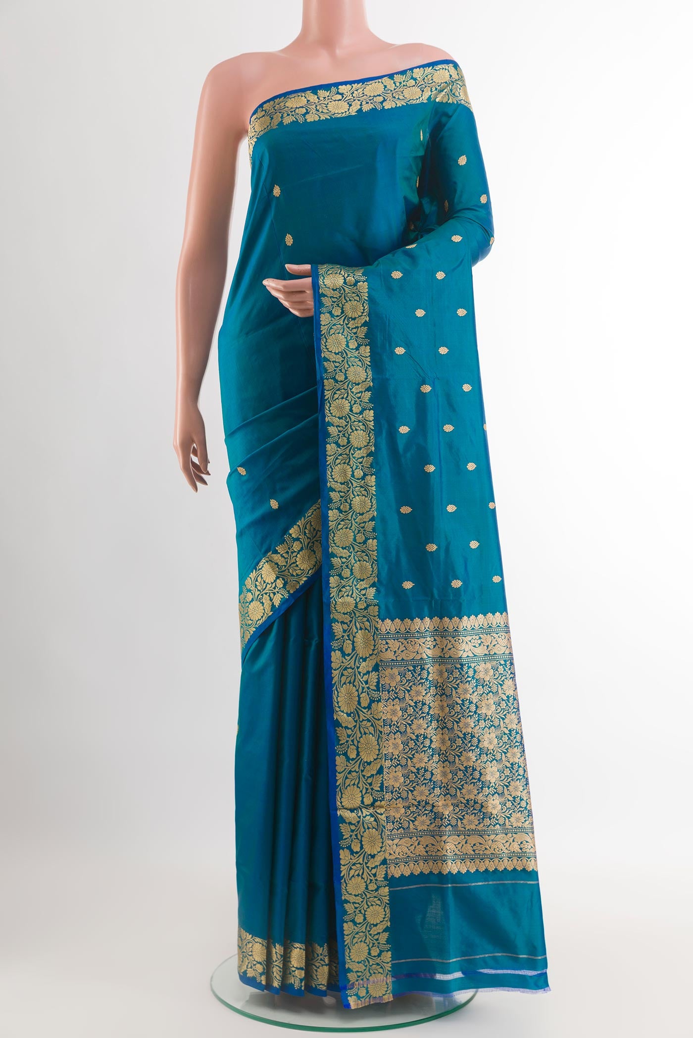 Blue Banarasi Katan Silk Saree with Zari Butta on the body and Zari Border.  displayed on a mannequin