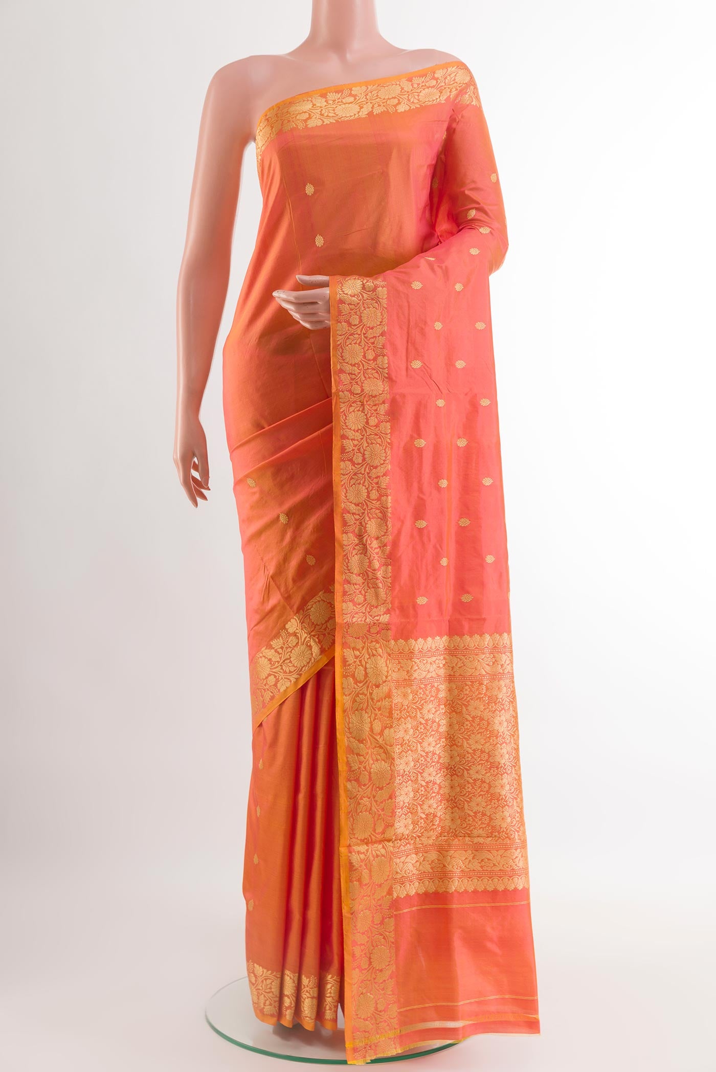 Peach Banarasi Katan Silk Saree with Zari Butta on the body and Zari Border.  displayed on a mannequin