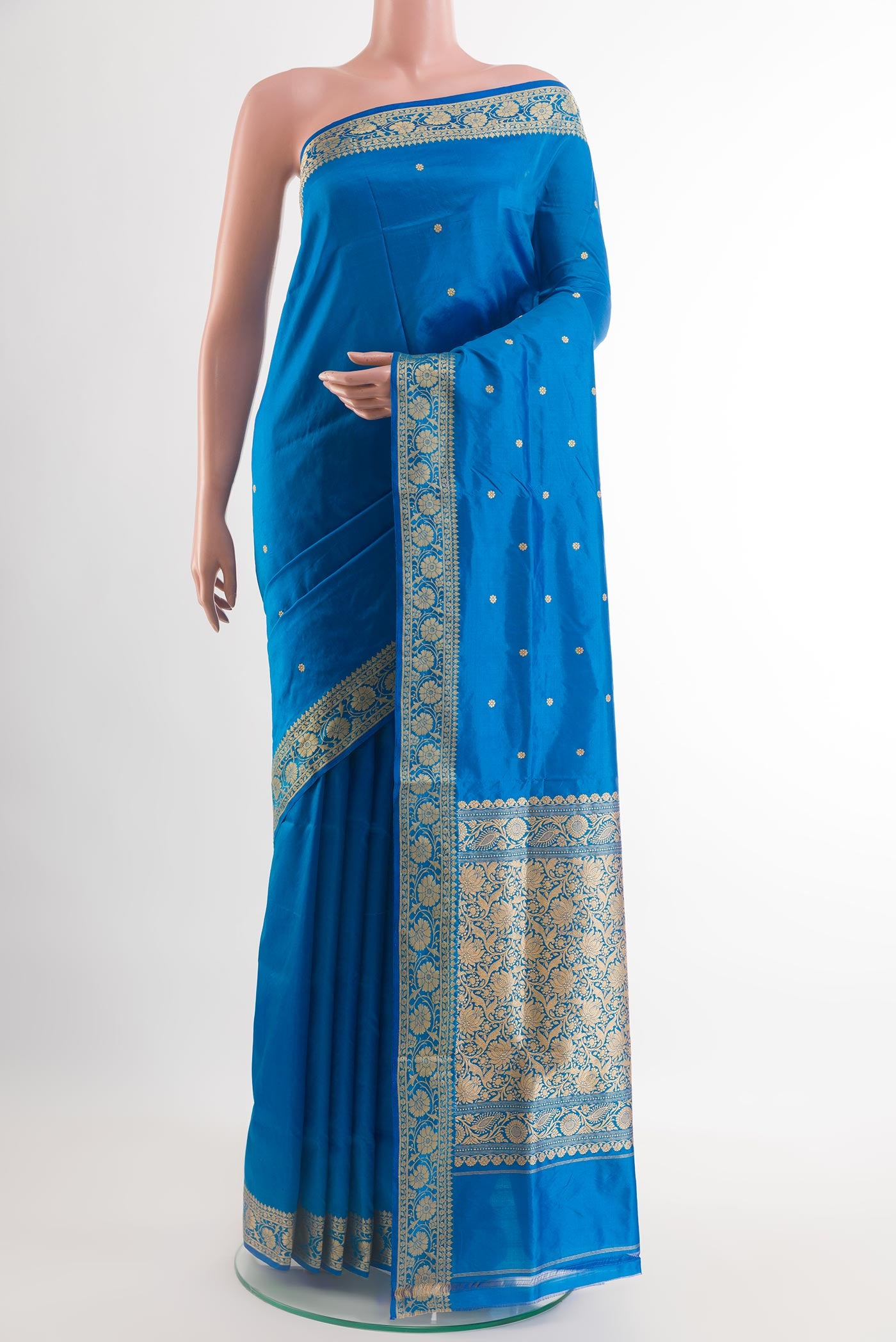 Blue Banarasi Katan Silk Saree with Zari Butta on the body and Zari Border.  displayed on a mannequin
