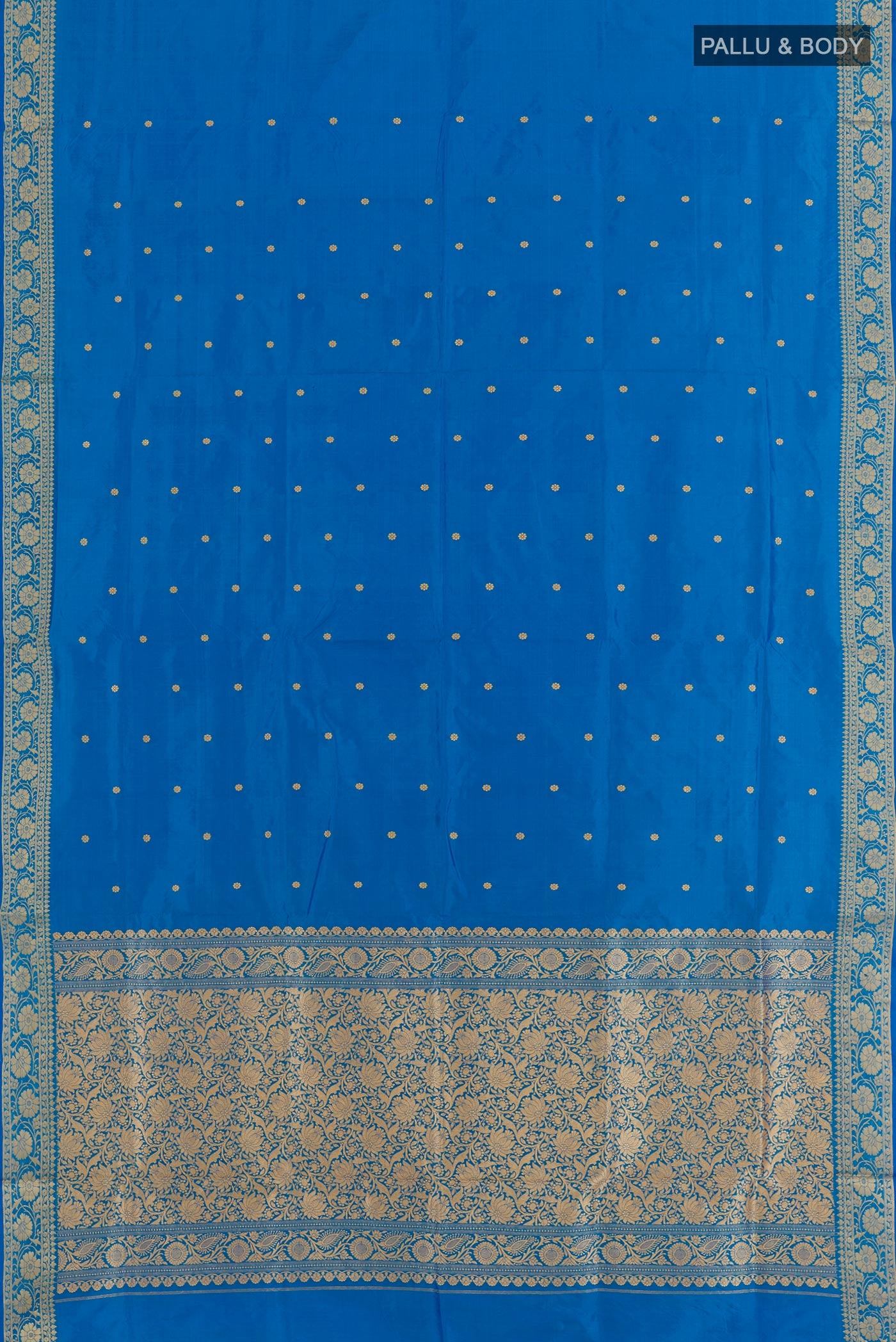 Flat view of Blue Banarasi Katan Silk Saree with Zari Butta on the body and Zari Border. 