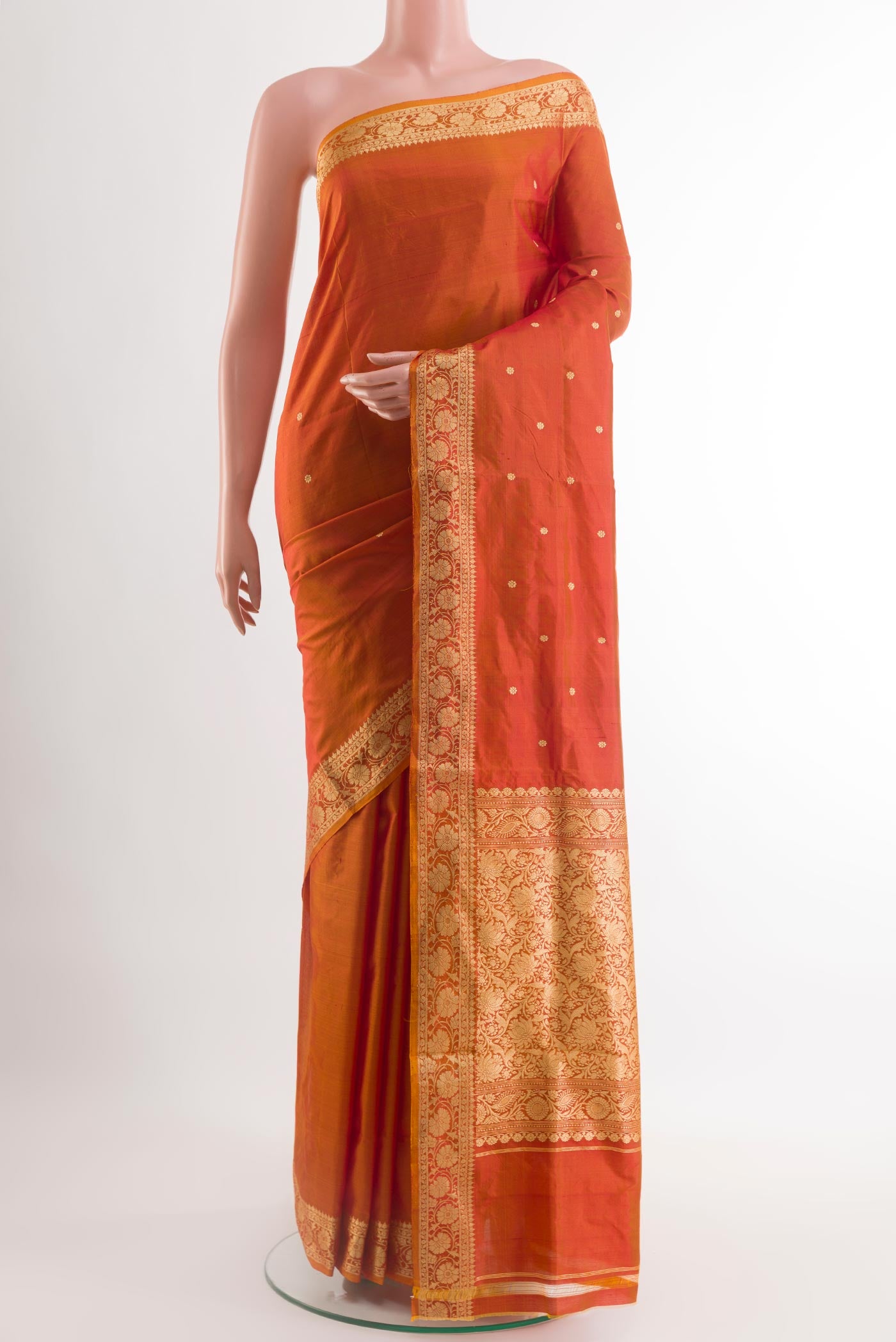 Orange Banarasi Katan Silk Saree with Zari Butta on the body and Zari Border.  displayed on a mannequin