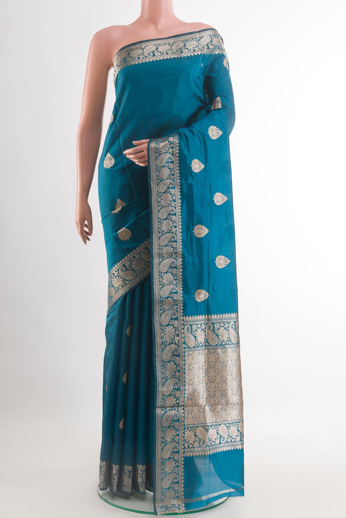 Blue Banarasi Katan Silk Saree with Zari Butta on the body and Zari Border.  displayed on a mannequin