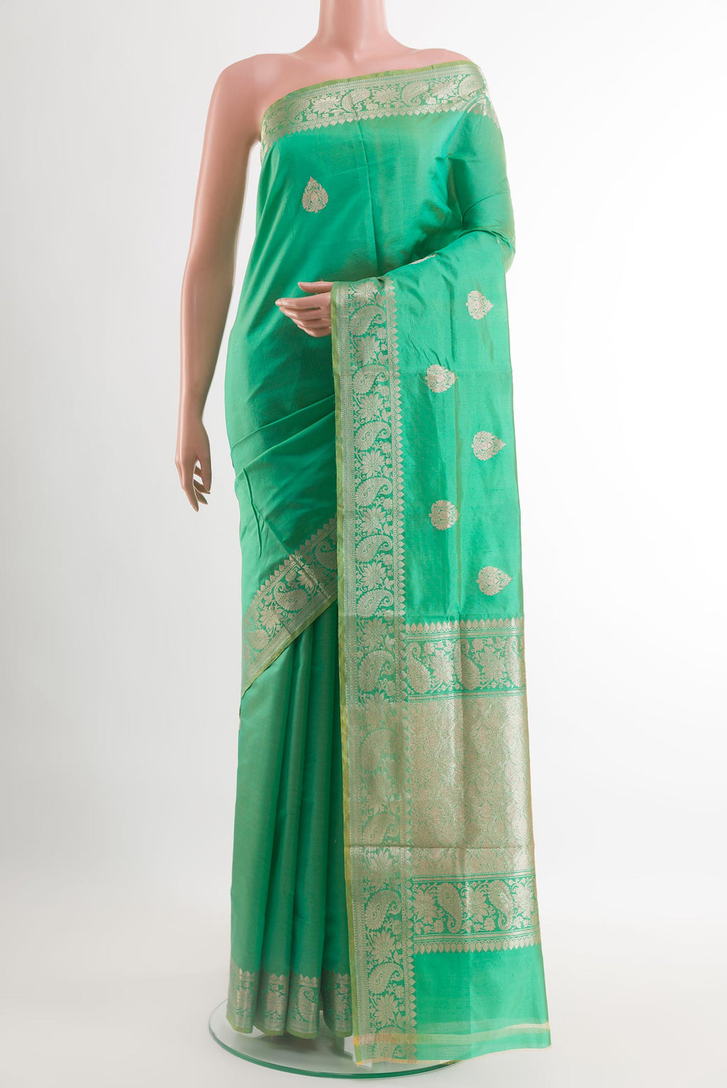 Green Banarasi Katan Silk Saree with Zari Butta on the body and Zari Border.  displayed on a mannequin