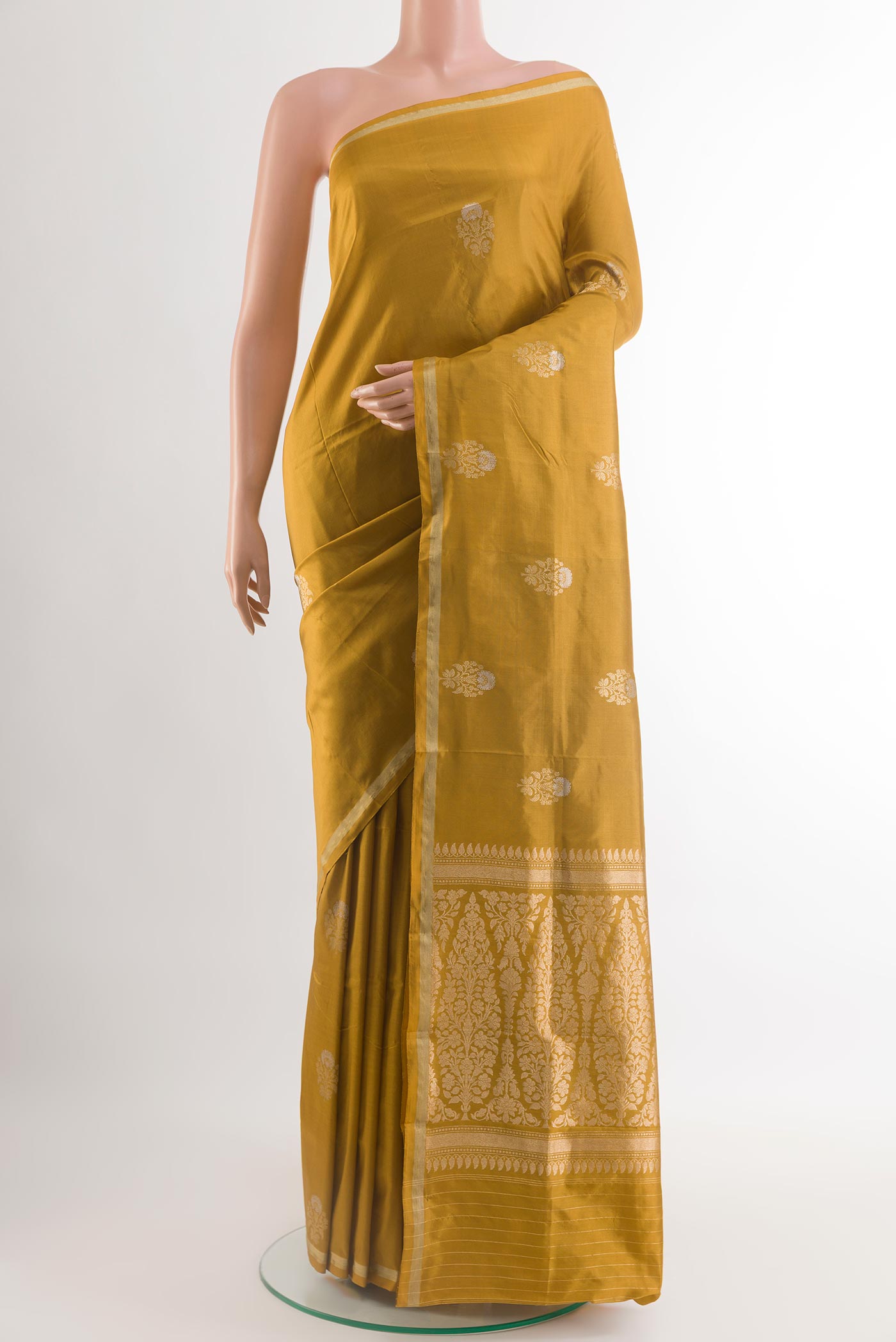 Mustard Banarasi Katan Silk Saree with Zari Butta on the body and Zari Border.  displayed on a mannequin