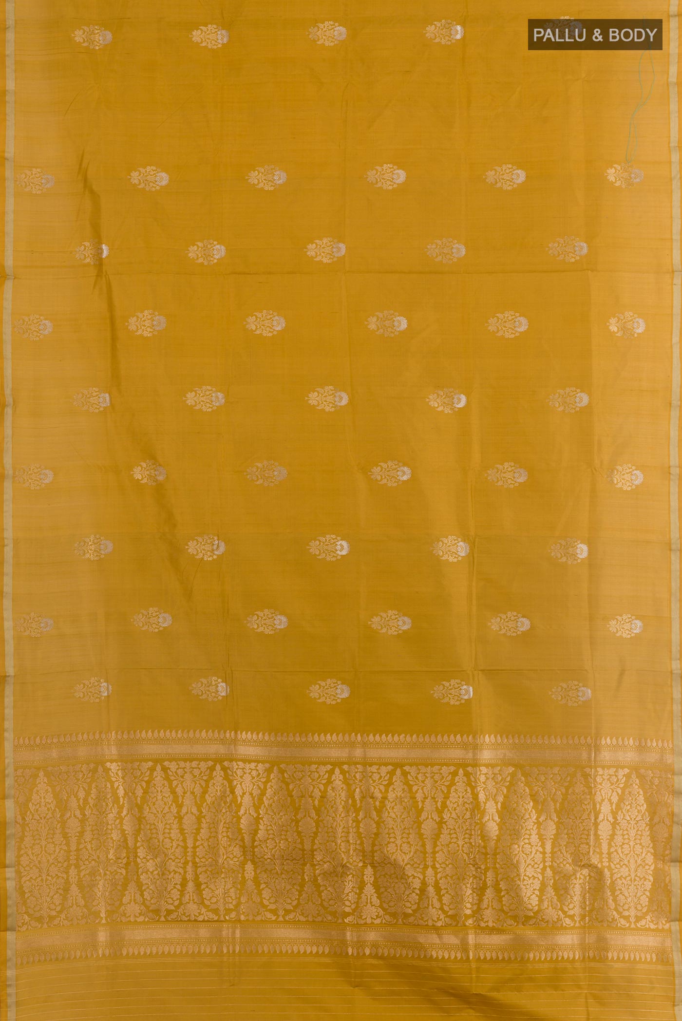 Flat view of Mustard Banarasi Katan Silk Saree with Zari Butta on the body and Zari Border. 
