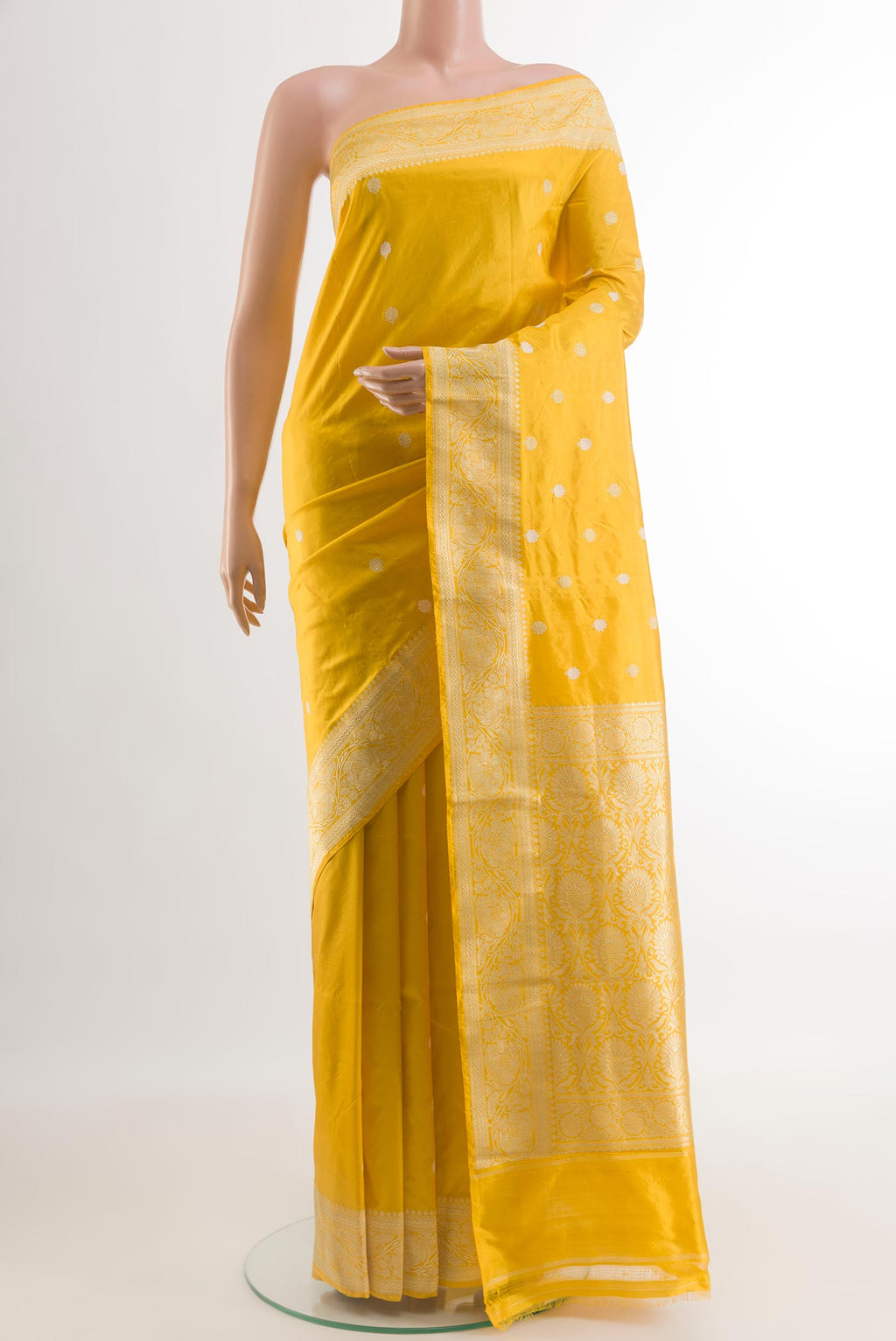 Yellow Banarasi Katan Silk Saree with Zari Butta on the body and Zari Border.  displayed on a mannequin