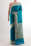 Blue Banarasi Katan Silk Saree with Zari Butta on the body and Zari Border.  displayed on a mannequin