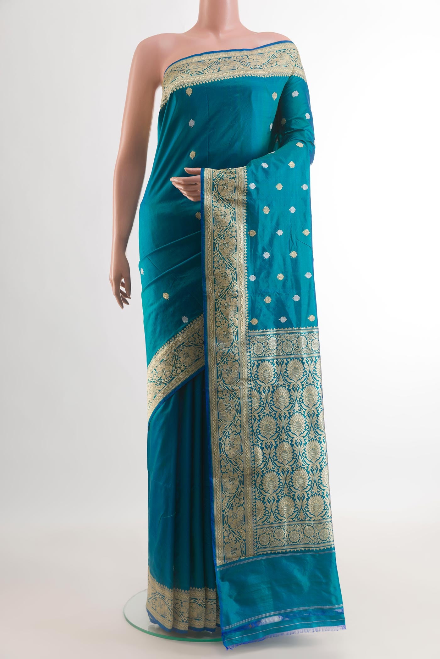 Blue Banarasi Katan Silk Saree with Zari Butta on the body and Zari Border.  displayed on a mannequin