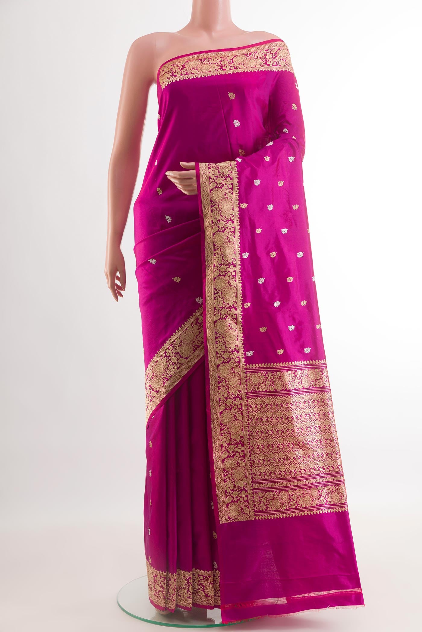 Magenta Banarasi Katan Silk Saree with Zari And Thread Butta on the body and Zari Border.  displayed on a mannequin