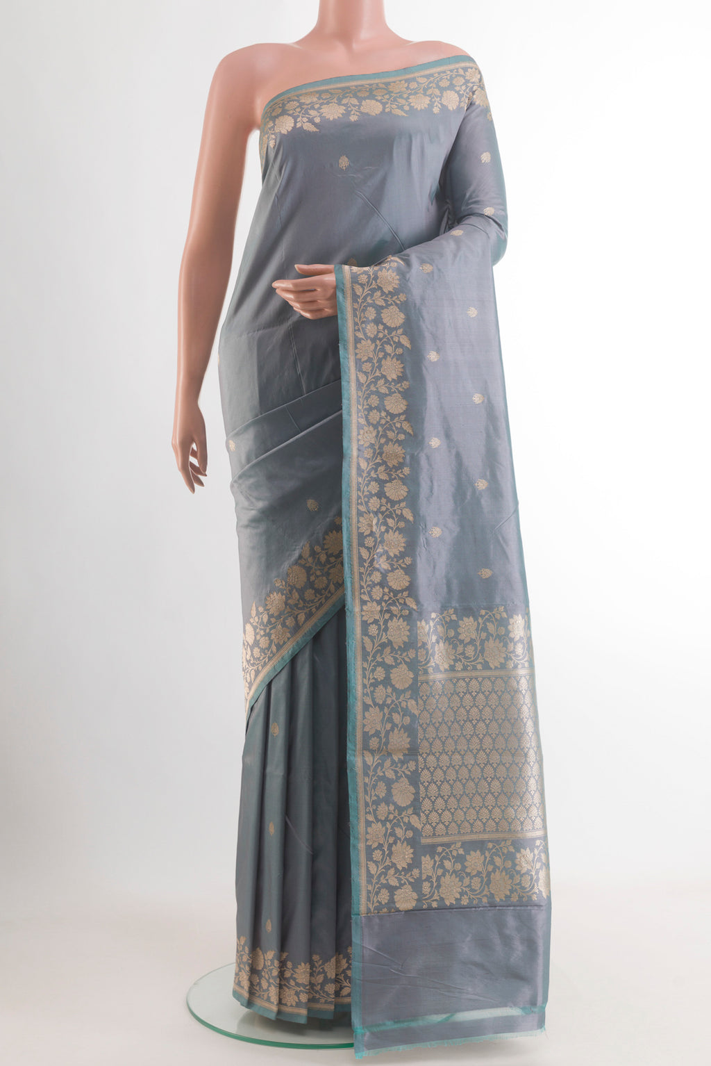 Grey Banarasi Katan Silk Saree with Zari Butta on the body and Zari Border.  displayed on a mannequin