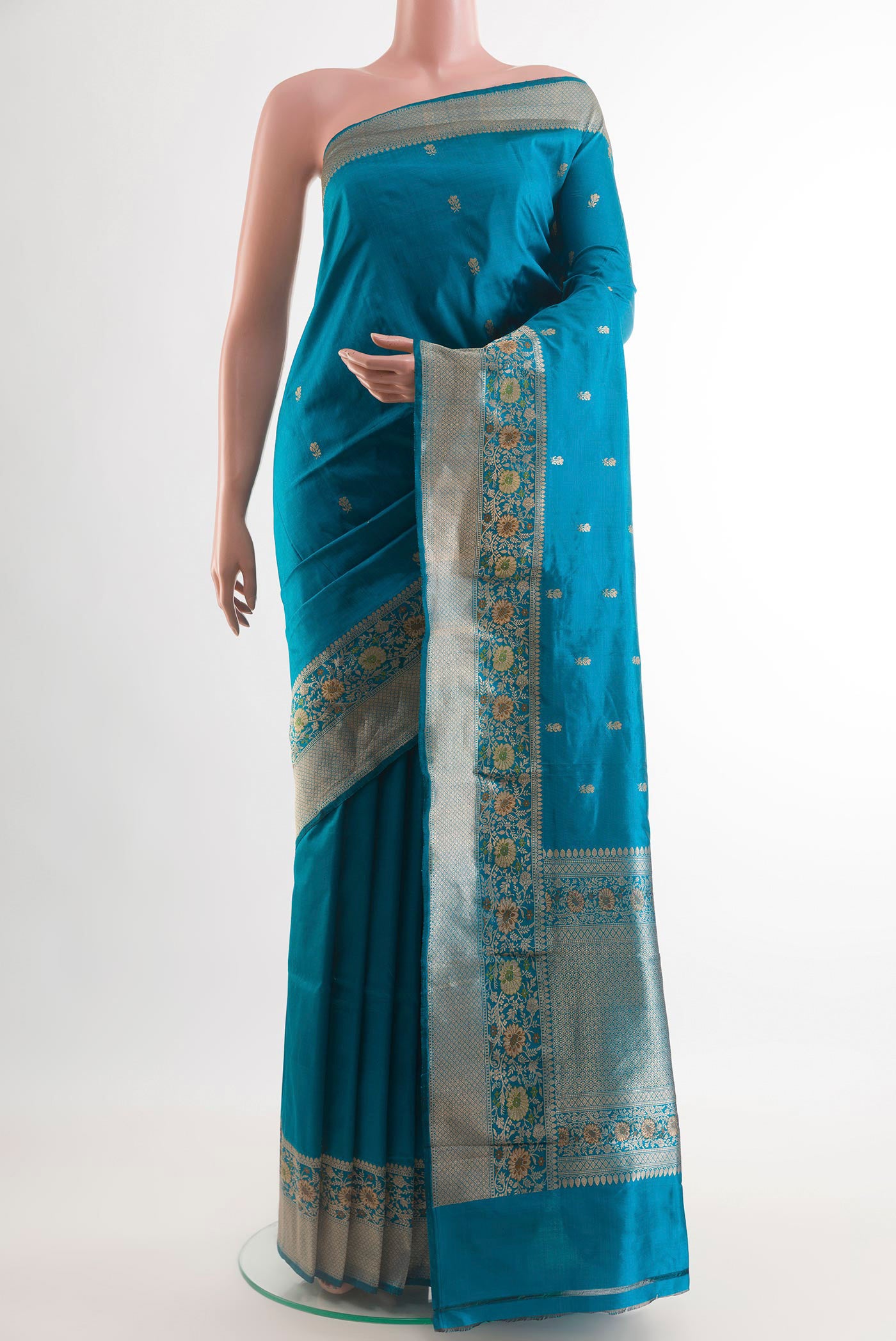 Blue Banarasi Katan Silk Saree with Zari Butta on the body and Zari Border.  displayed on a mannequin