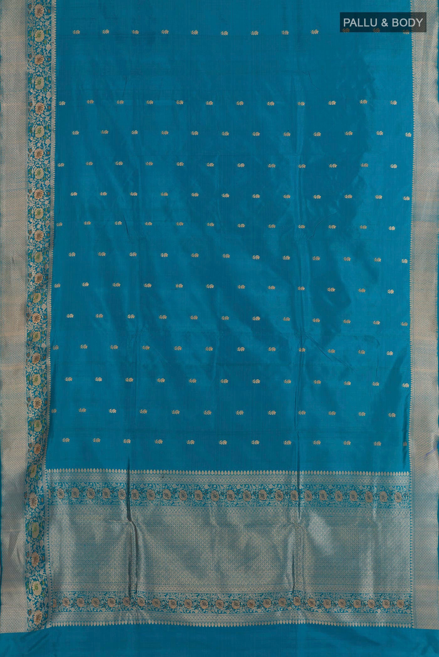 Flat view of Blue Banarasi Katan Silk Saree with Zari Butta on the body and Zari Border. 