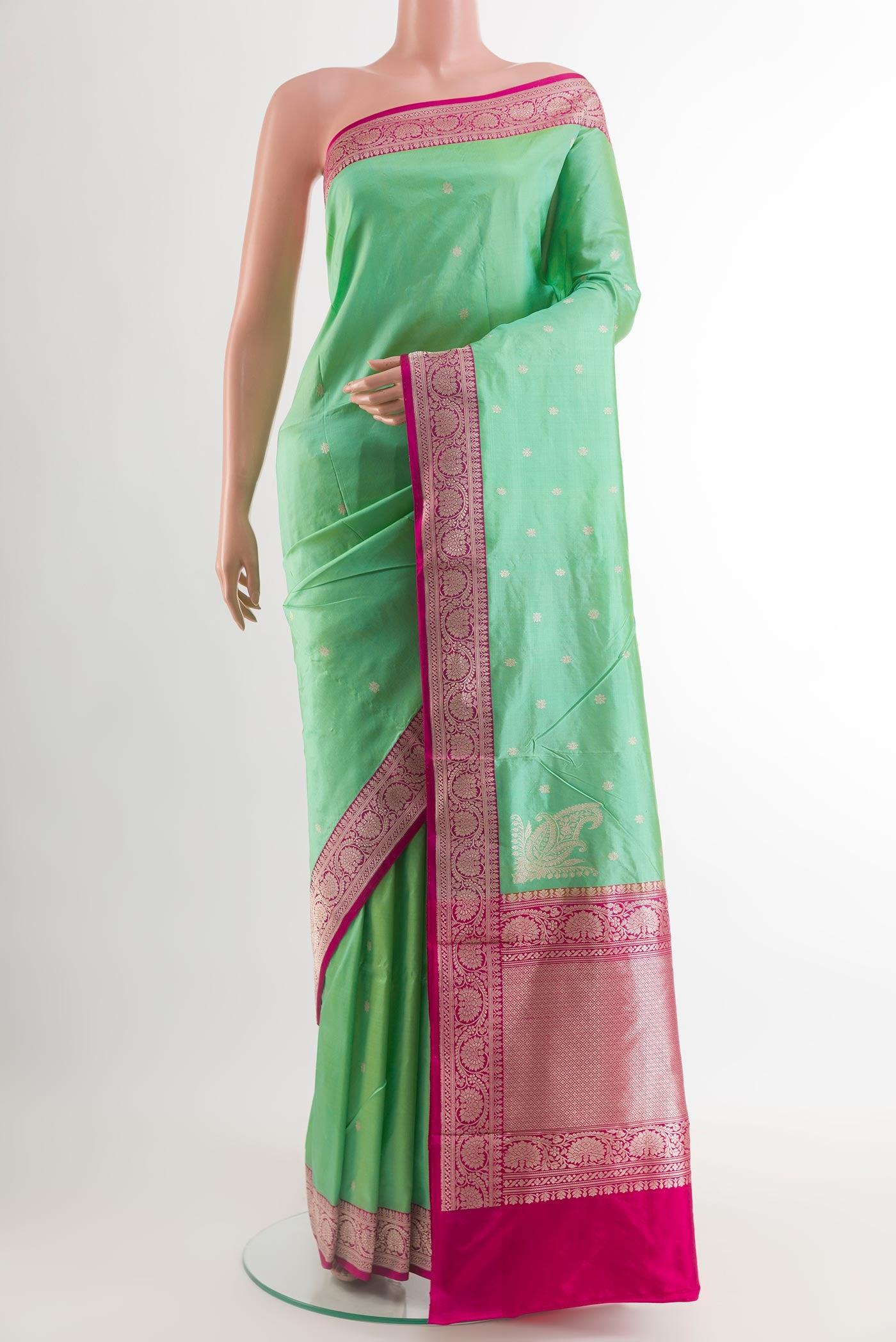 Green Banarasi Katan Silk Saree with Zari Butta on the body and Zari Border.  displayed on a mannequin