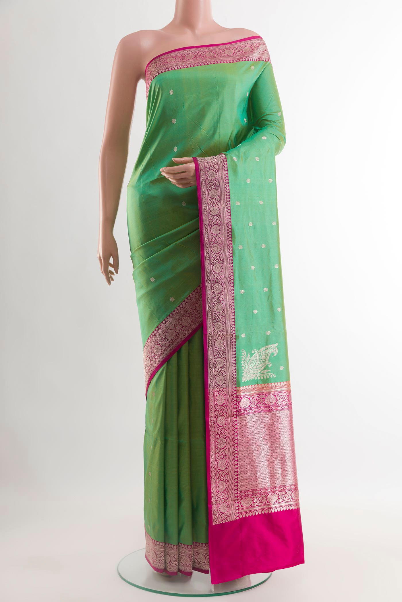 Green Banarasi Silk Saree with Zari Butta on the body and Zari Border.  displayed on a mannequin