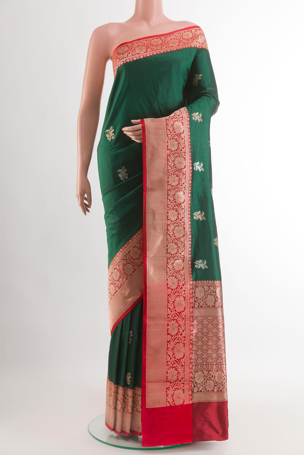 Bottle Green Banarasi Katan Silk Saree with Zari Butta on the body and Zari Border.  displayed on a mannequin