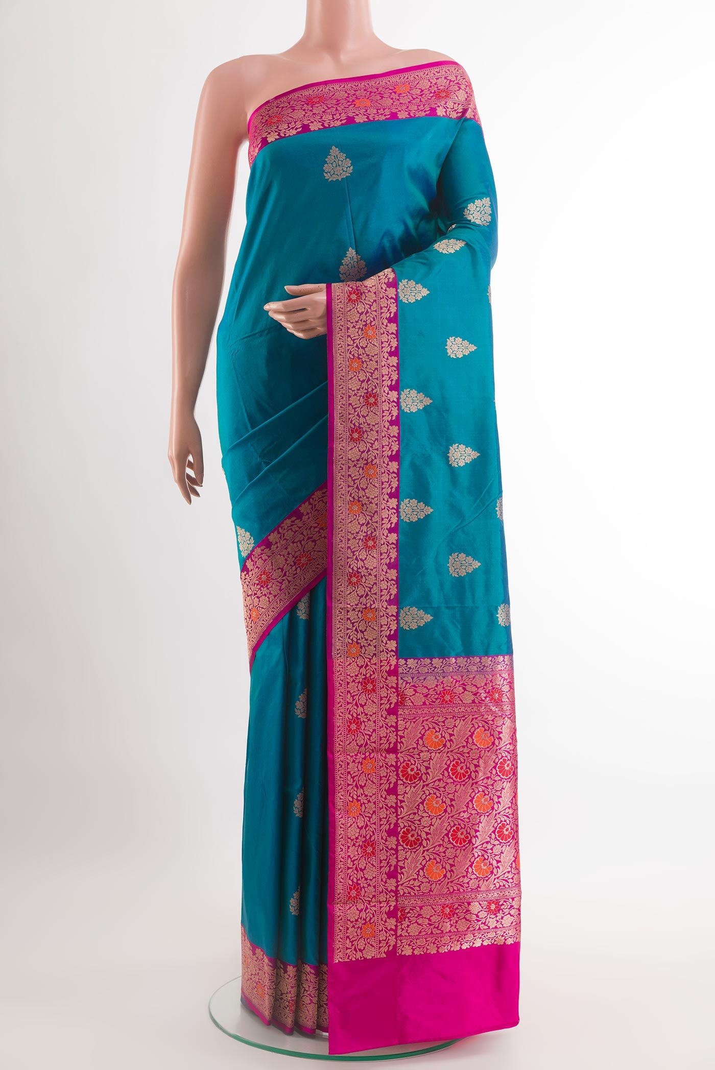 Blue Banarasi Katan Silk Saree with Zari Butta on the body and Zari Border.  displayed on a mannequin