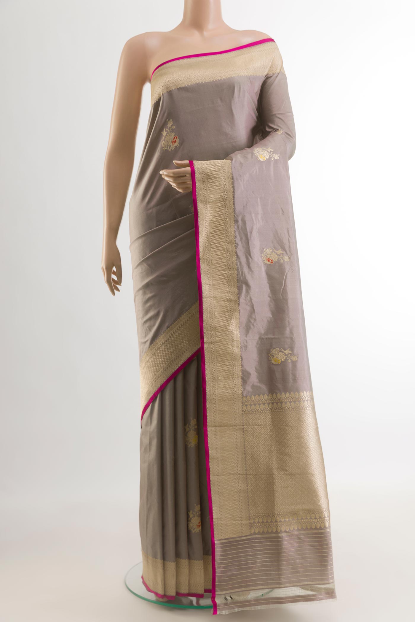 Grey Banarasi Katan Silk Saree with Zari Butta on the body and Zari Border.  displayed on a mannequin