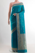 Peacock Blue Banarasi Katan Silk Saree with Zari Butta on the body and Zari Border.  displayed on a mannequin