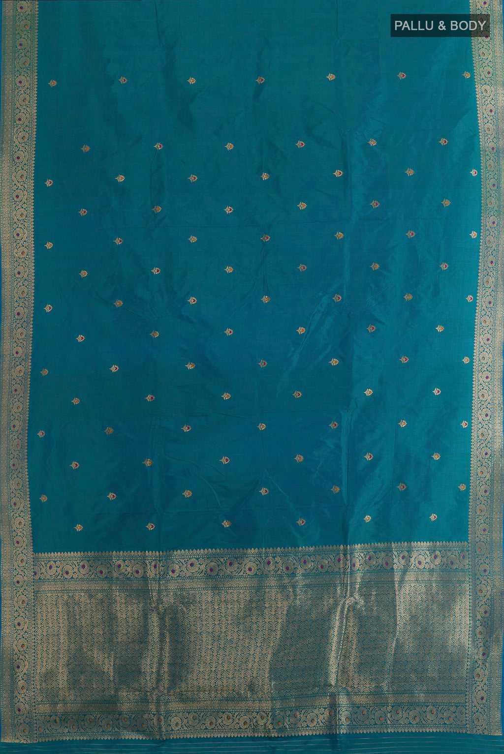 Flat view of Peacock Blue Banarasi Katan Silk Saree with Zari Butta on the body and Zari Border. 