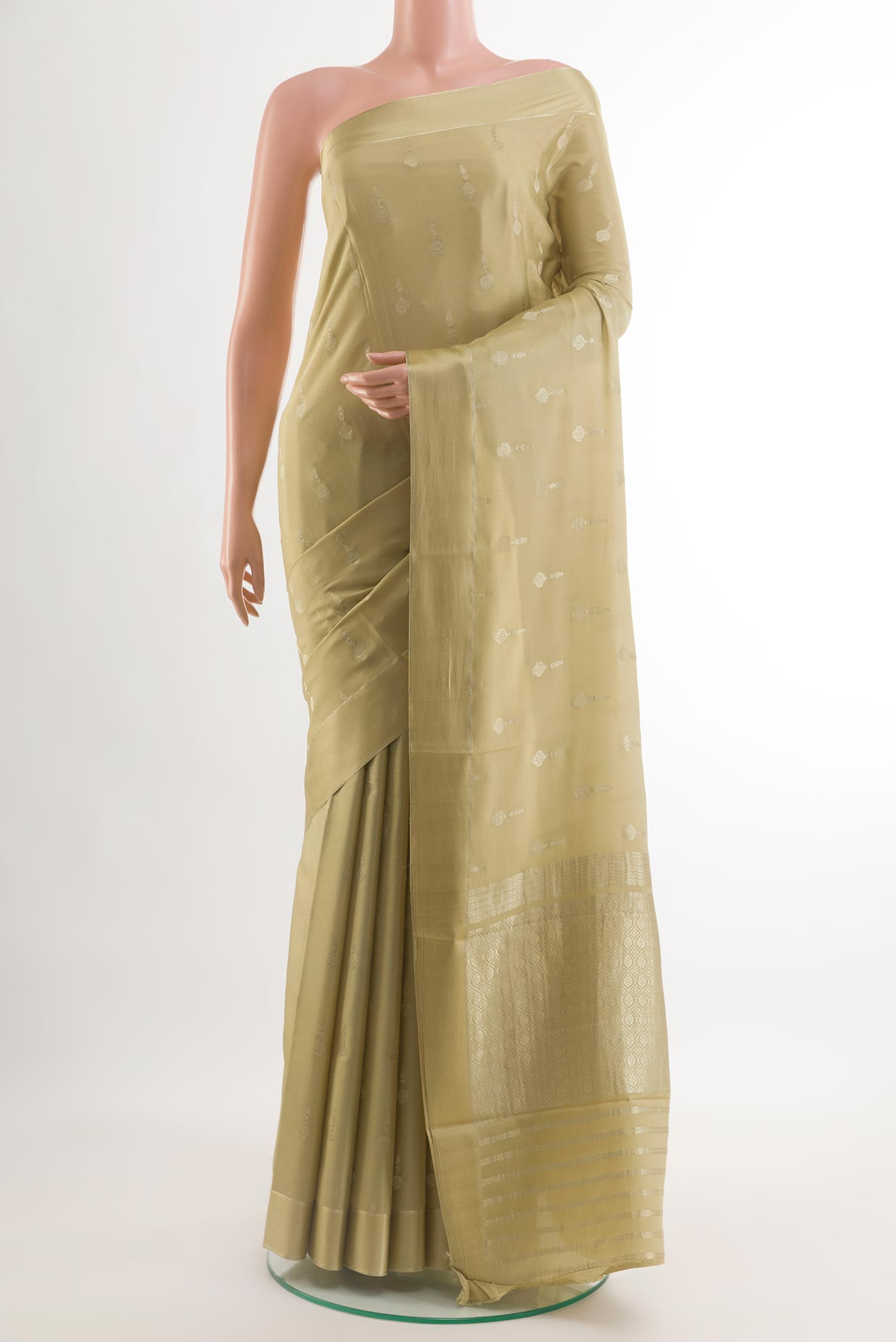 Beige Mysore Crepe Saree with Zari Butta on the body and Zari Border.  displayed on a mannequin