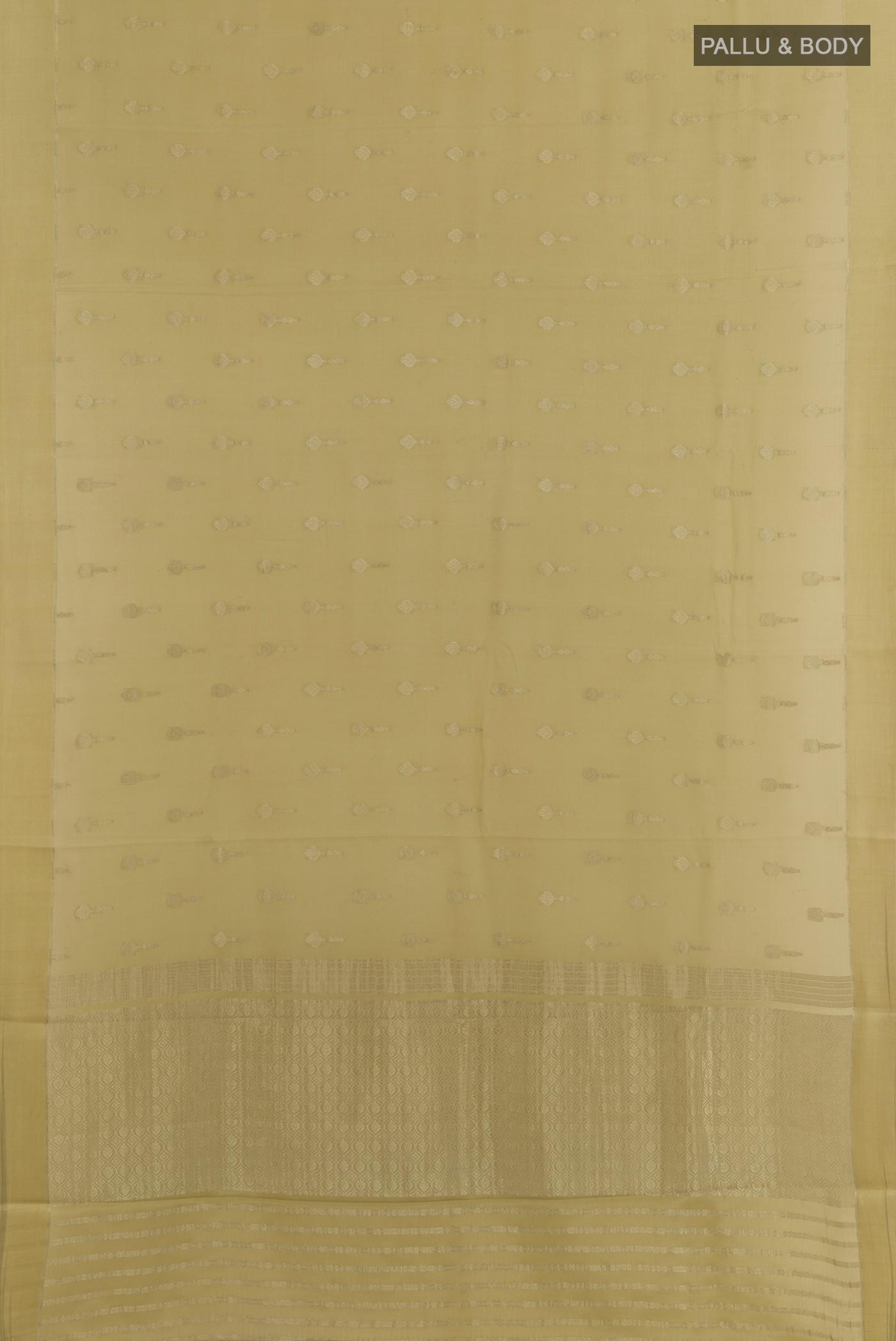 Flat view of Beige Mysore Crepe Saree with Zari Butta on the body and Zari Border. 