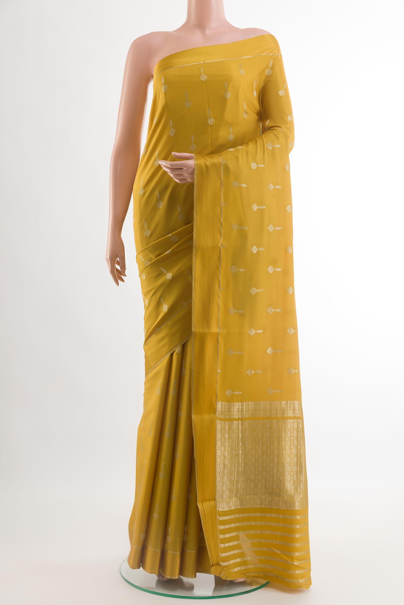 Yellow Mysore Crepe Saree with Zari Butta on the body and Zari Border.  displayed on a mannequin