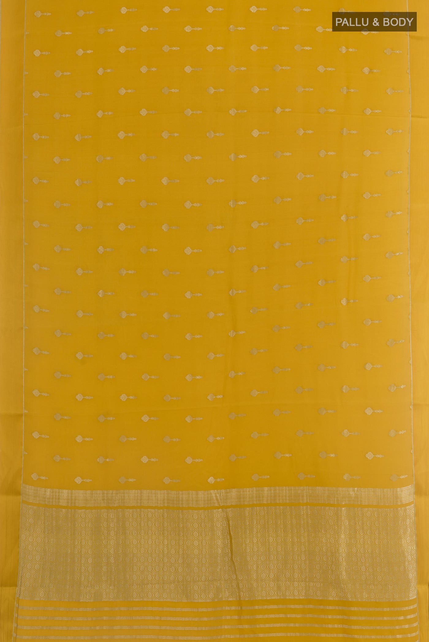 Flat view of Yellow Mysore Crepe Saree with Zari Butta on the body and Zari Border. 