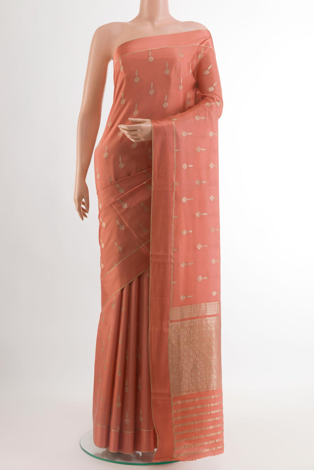 Peach Mysore Crepe Saree with Zari Butta on the body and Zari Border.  displayed on a mannequin